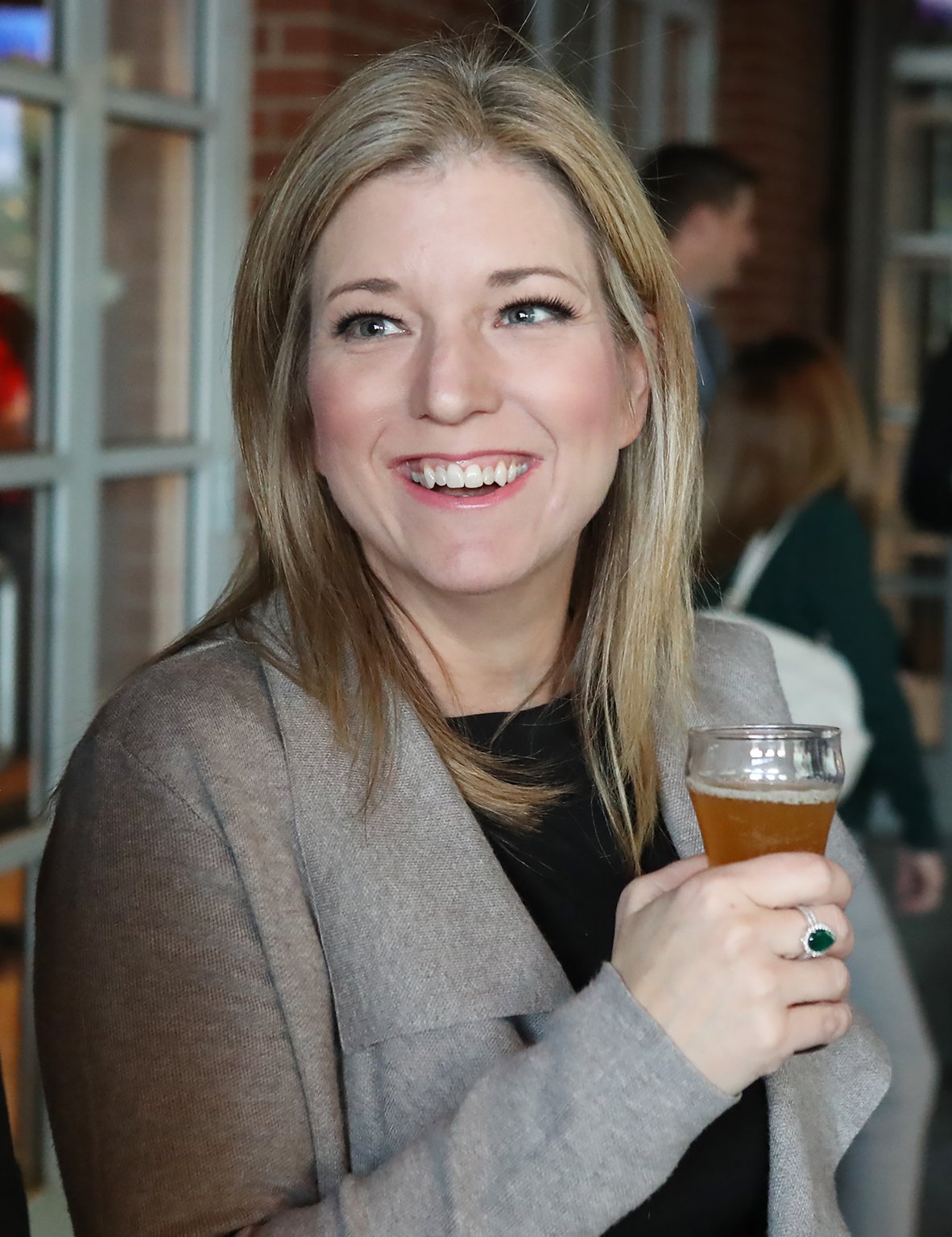 Sen. Jen Jordan (Atlanta) is all smiles tasting her Georgia Peach wheat beer. Jordan was among the lawmakers competing in the first Brew Across Georgia, staged Wednesday evening at the Taco Mac in Dunwoody. Curtis Compton/ccompton@ajc.com