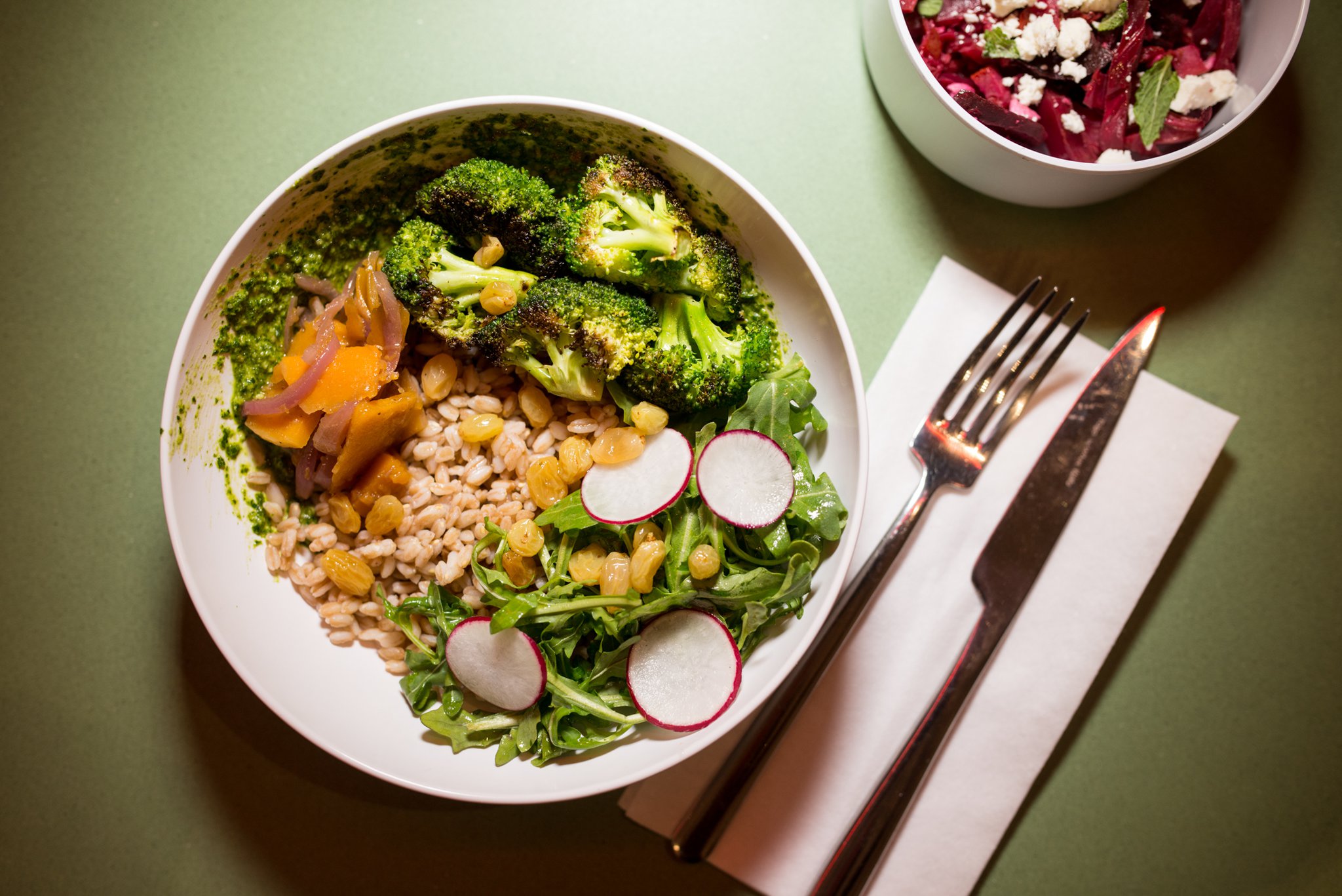 My Farro Lady Bowl with kale pesto, broccoli, butternut squash, pickled red onion, arugula, radish, and golden raisins. Photo credit- Mia Yakel.
