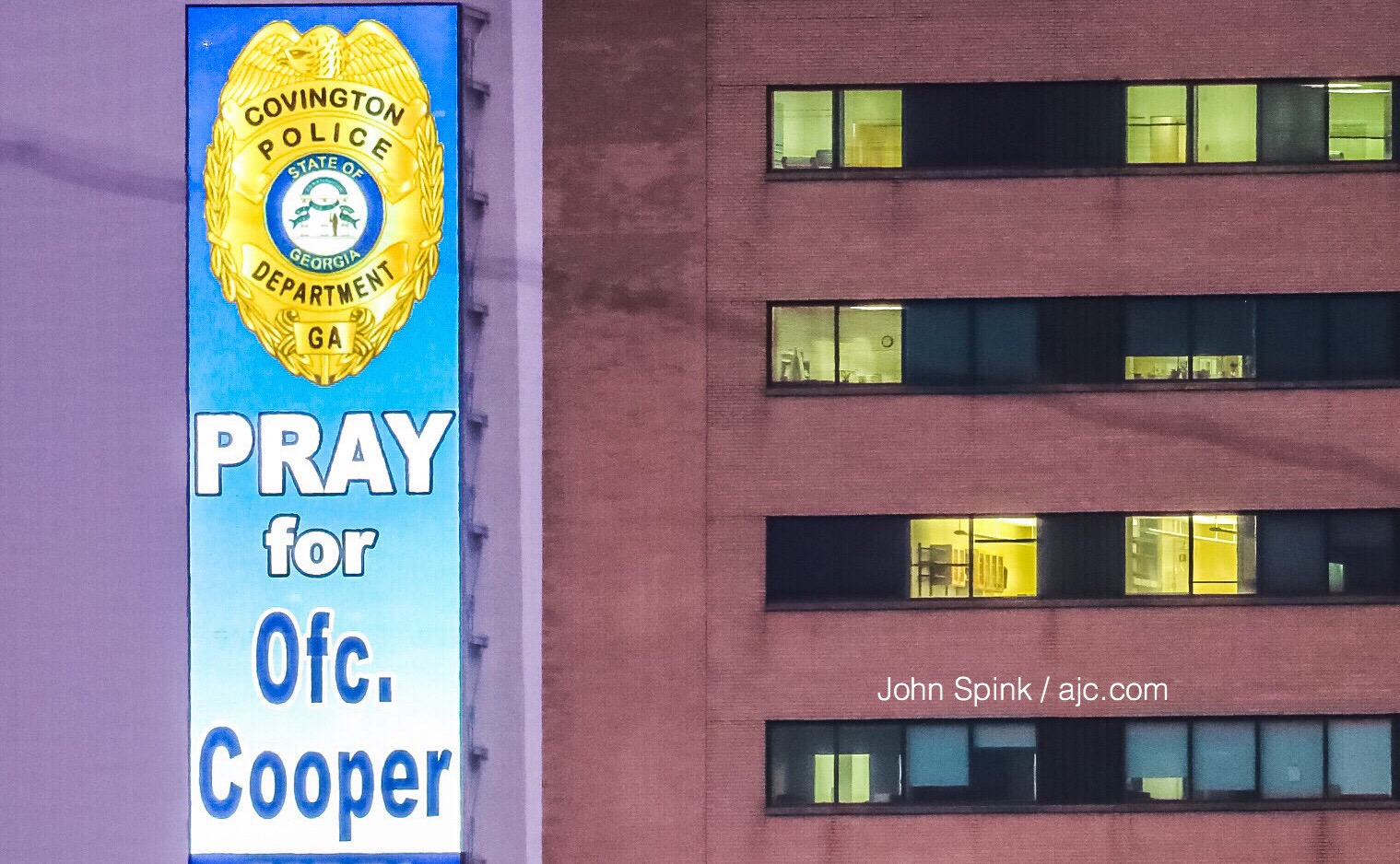 A sign supporting wounded Covington police Officer Matt Cooper is displayed outside Grady Memorial Hospital, within view of Cooper's hospital room. JOHN SPINK / JSPINK@AJC.COM