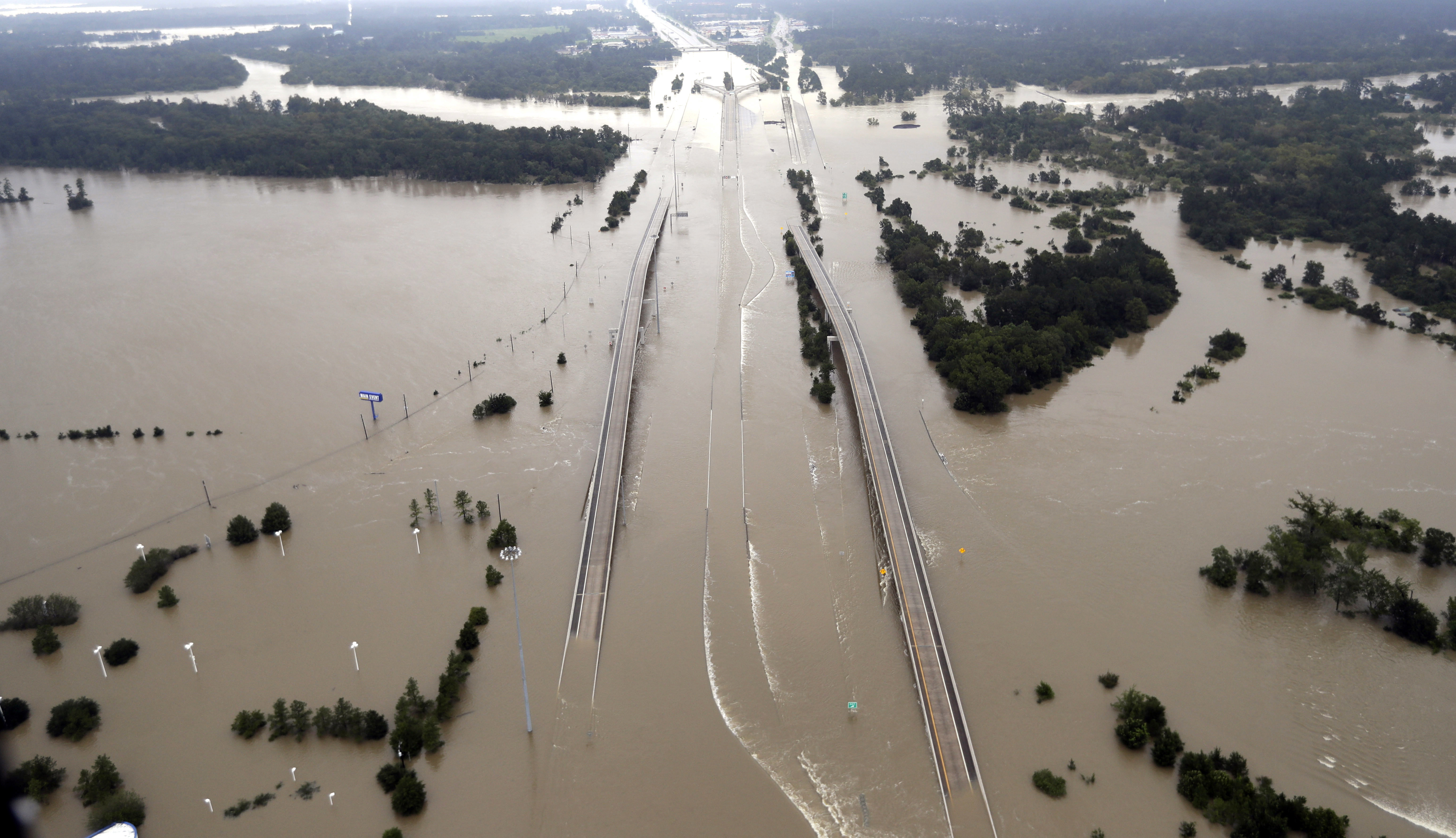 In this Aug. 29, 2017 file photo, Interstate 69 is covered by floodwaters from Harvey, in Humble, Texas. Just two weeks ago, President Donald Trump rolled back an order by his predecessor that would have made it easier for storm-ravaged communities to use federal emergency aid to rebuild bridges, roads and other construction so they can better withstand future disasters. That decision is now being questioned with the Texas Gulf Coast and much of Houston under water in the wake of Harvey. (AP Photo/David J. Phillip, File)