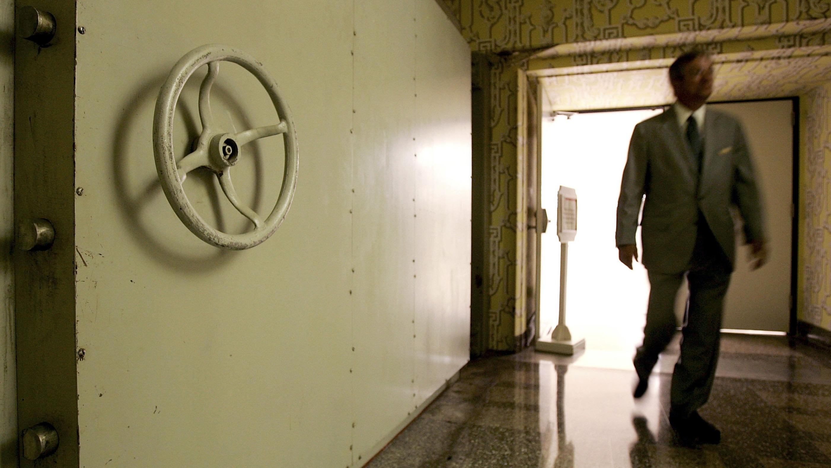 WHITE SULPHUR SPRINGS, WV - JULY 14: A resort employee passes by the Hotel Blast Door, which weighs 18 tons and serves as an entrance to a former government relocation facility, also know as "the bunker," at Greenbrier Resort July 14, 2006 in White Sulphur Springs, West Virginia. The bunker, codenamed "Project Greek Island" and planned by the Eisenhower Administration, was a 112,000 square-foot shelter constructed beneath the Greenbrier Resort's West Virginia Wing, to serve as a relocation site for members of the U.S. Congress and associated staff in the event of a nuclear attack on the U.S. soil. The facility was built between 1958 and 1961 and was maintained in a state of operational readiness until the government terminated the lease with the resort in 1995. The bunker will be reopened for public tours on August 20 after a two-year-long renovation. (Photo by Alex Wong/Getty Images)
