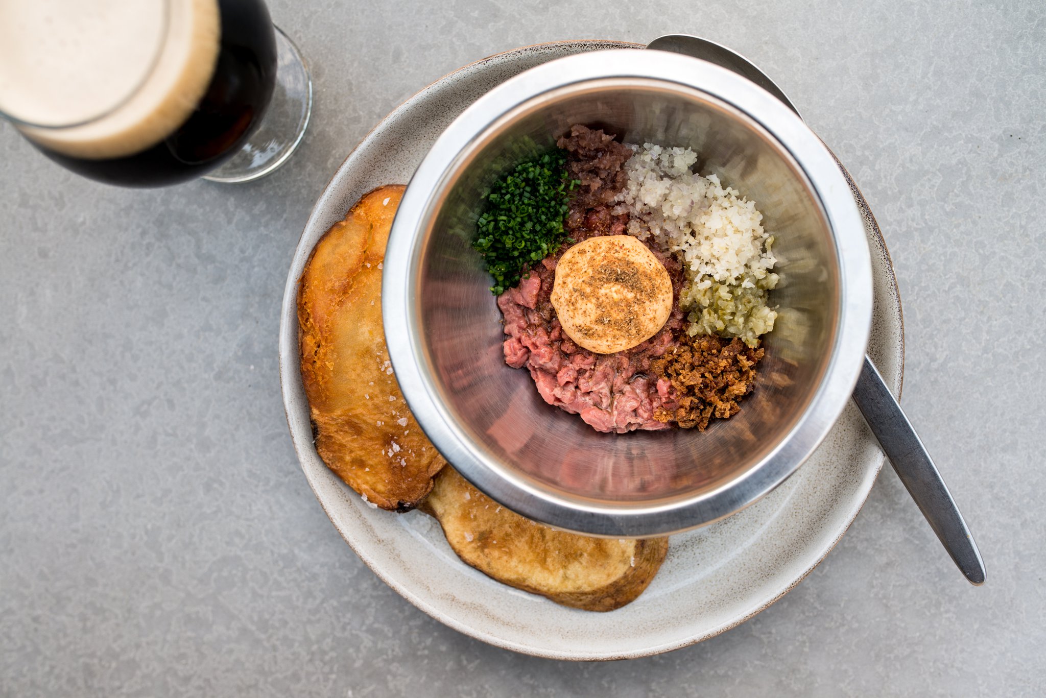 The Dry Aged Beef Tartare with Russian dressing and caraway vinegar is mixed tableside at Cold Beer.