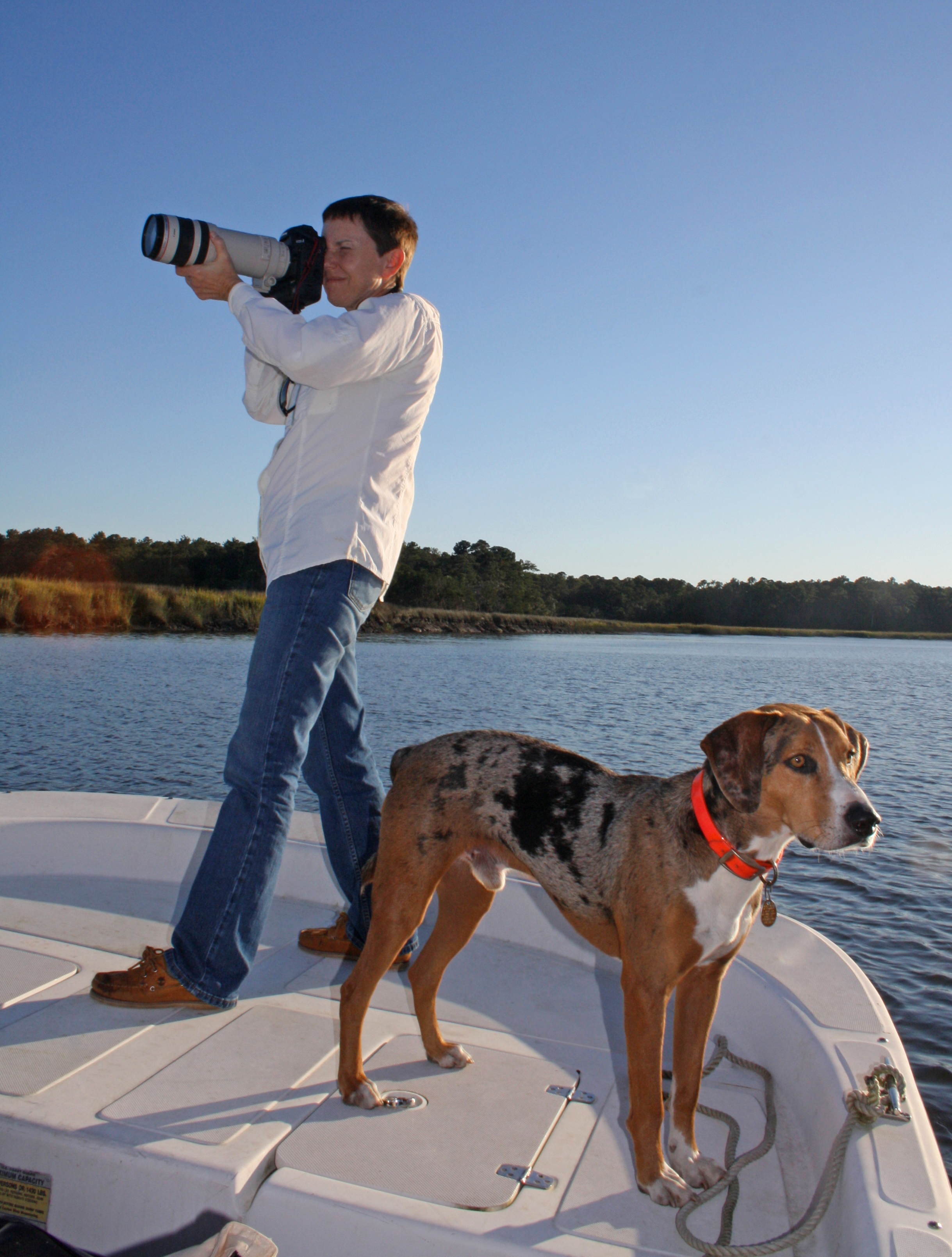 Stuckey in action taking photos on Ossabaw Island, accompanied by her faithful canine companion Blaze. Another friend, former President Jimmy Carter, wrote the foreword for the new book "Ossabaw Island: A Sense of Place," in which some 105 of Stuckey's photos appear. Photo by Matthew Page