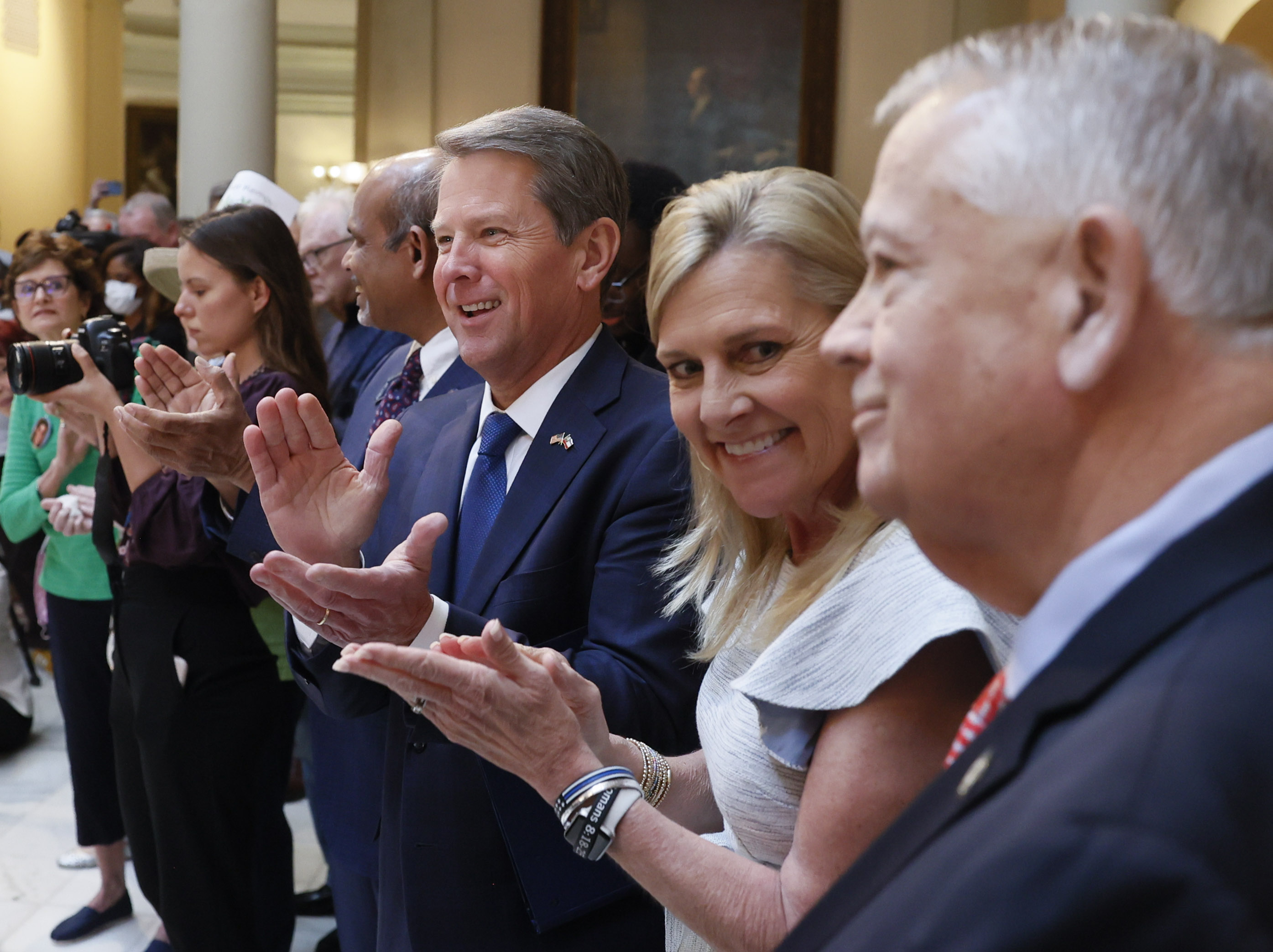 Gov. Brian Kemp, with his wife, Marty, applauds House Speaker Ralston before he signed HB 1013, which aims to increase access to mental health coverage in Georgia on Sine Die, the last day of the General Assembly at the Georgia State Capitol in Atlanta on Monday, April 4, 2022. (Bob Andres / robert.andres@ajc.com)