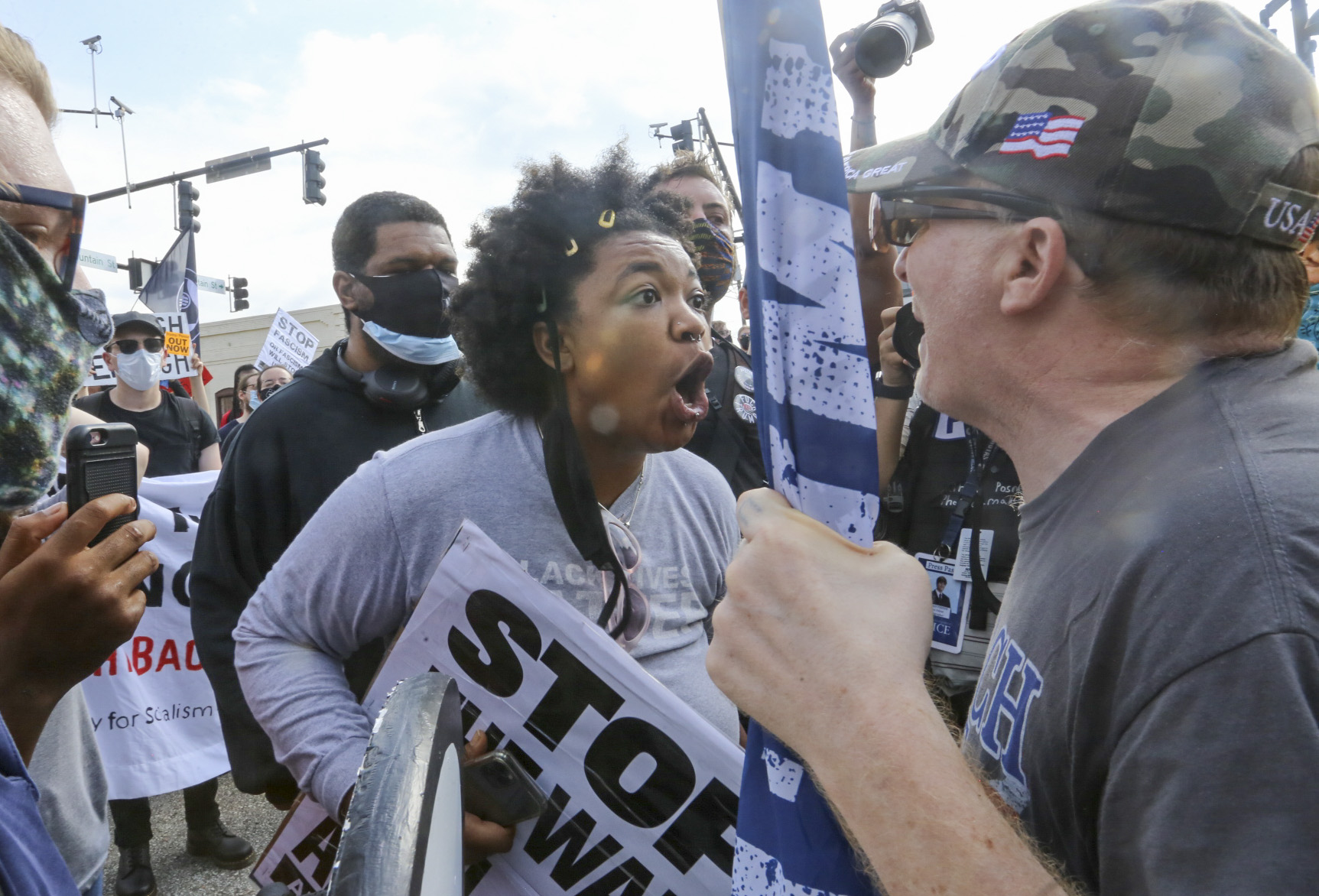 8/15/20 - Stone Mountain, GA - Counter protesters face off with protesters as several far-right groups, including militias and white supremacists, rally Saturday in the town of Stone Mountain, and a broad coalition of leftist anti-racist groups organized a counter-demonstration there after local authorities closed Stone Mountain park. Jenni Girtman for the Atlanta Journal Constitution