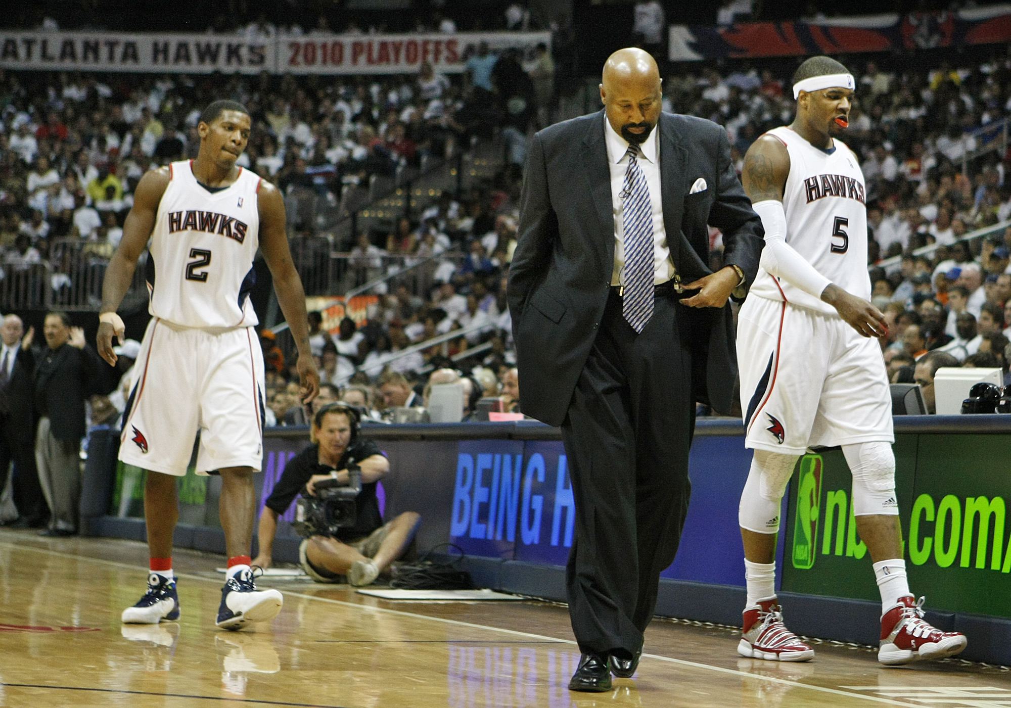 Atlanta Hawks head coach Mike Woodson, guard Joe Johnson (2), and forward Josh Smith (5) head to the bench for a time out during the second half of a 105-75 loss to the Orlando Magic in game 3 of the Eastern Conference semifinals Saturday, May 8, 2010, at Philips Arena in Atlanta. (Curtis Compton/ccompton@ajc.com)