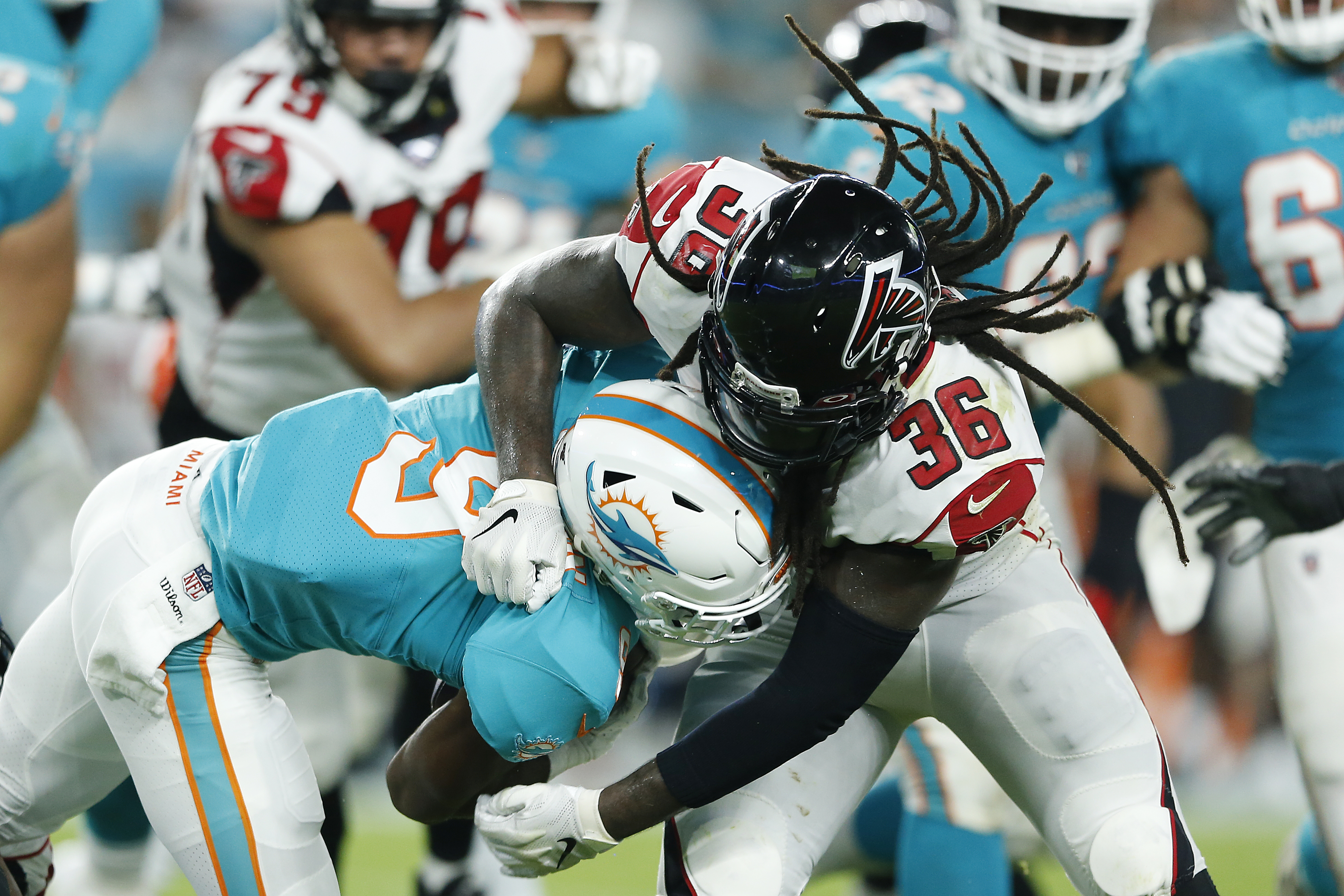 Kemal Ishmael #36 of the Atlanta Falcons tackles Mark Walton #9 of the Miami Dolphins during the first quarter of the preseason game at Hard Rock Stadium on August 08, 2019 in Miami, Florida. (Photo by Michael Reaves/Getty Images)