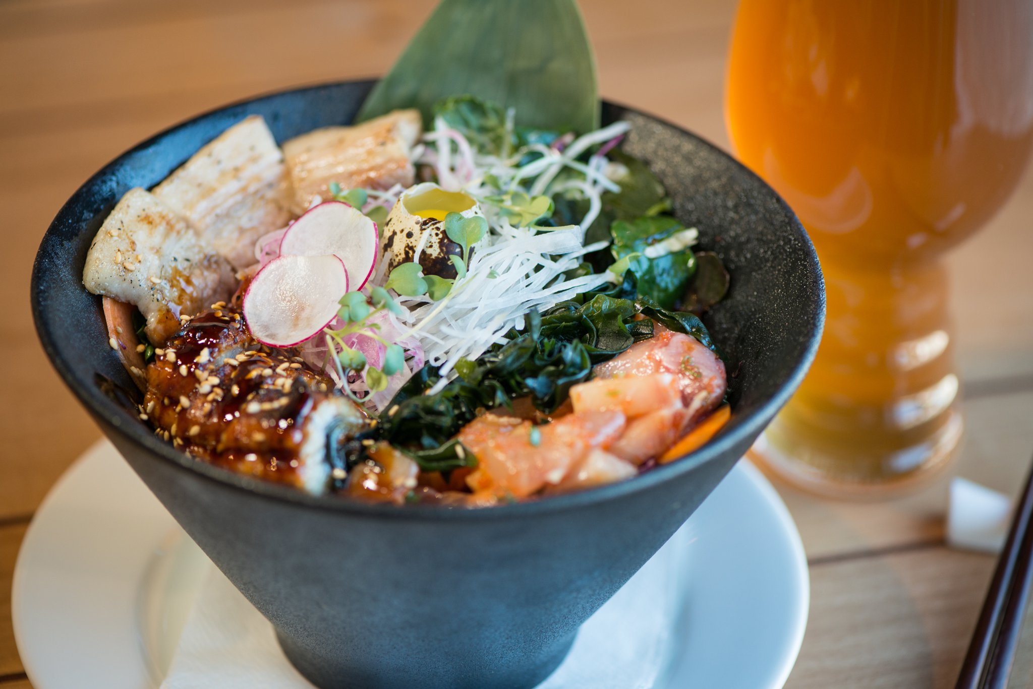 Hopstix Superbowl with sashimi cubes, scallion, masago, sesame seeds, ginger, spring mix, ponzu, sushi rice, and zuke sauce. Pictured with Max Lager's Hopslosion. Photo credit- Mia Yakel.