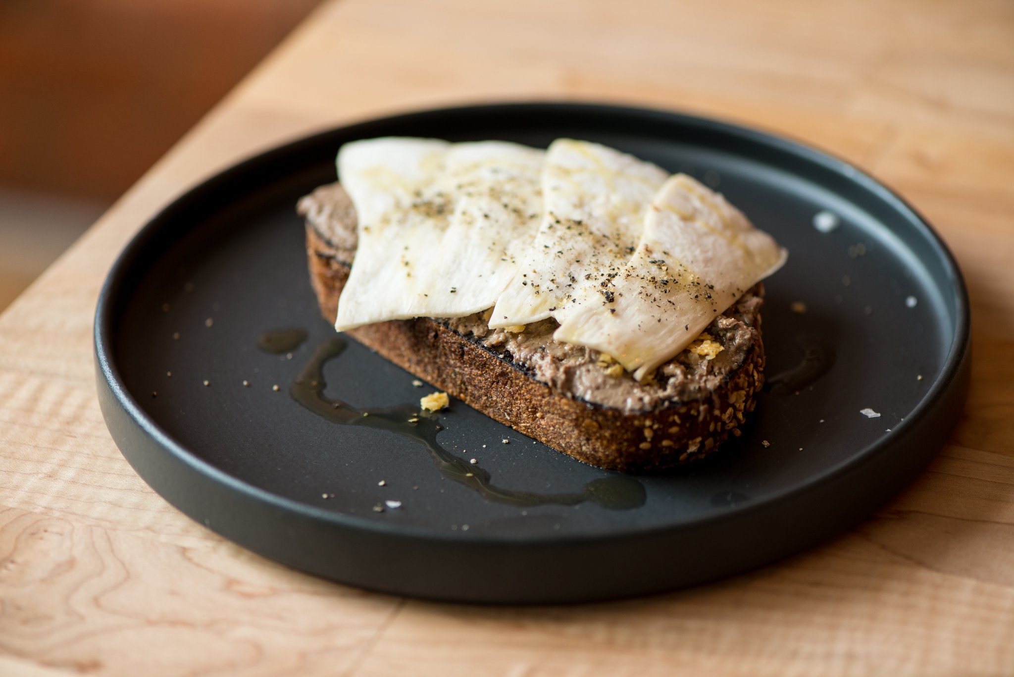 Chicken livers, toast, honey, frico, king trumpet mushrooms. Photo credit- Mia Yakel.