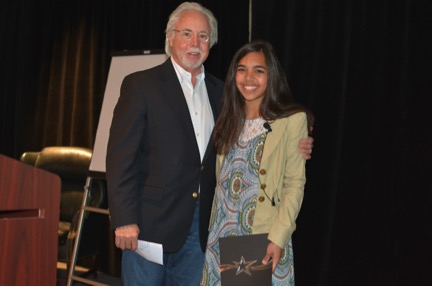 Hannah Testa (right) of Cumming was awarded with the Pioneer of Sustainability award from Ted’s Montana Grill CEO, George McKerrow (left) at the restaurant’s 2016 annual conference.