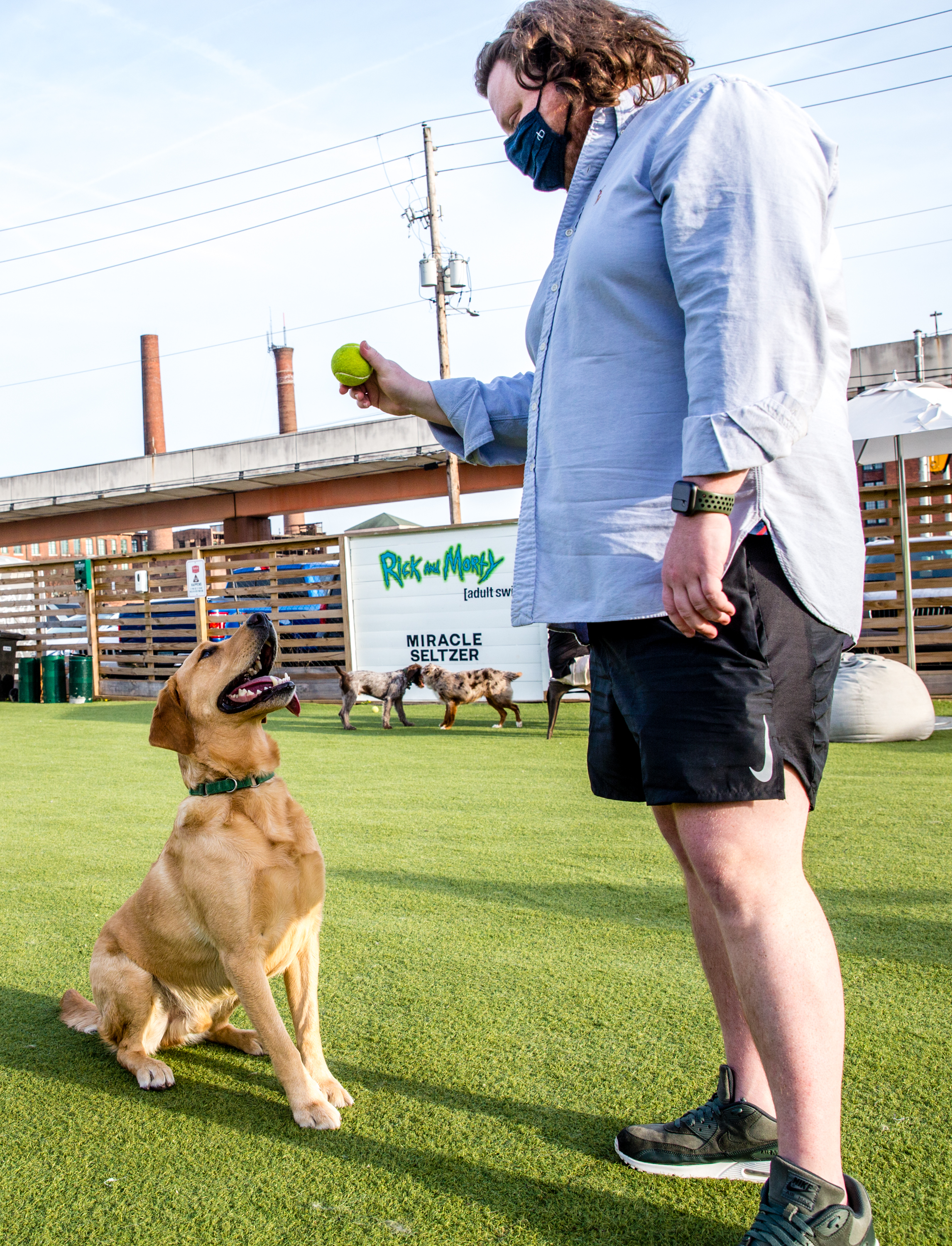 Matt Matuszewski and his yellow lab Murphy play at Fetch Park at Boulevard and DeKalb Ave on Friday, March 12, 2021. (Jenni Girtman for The Atlanta Journal-Constitution)