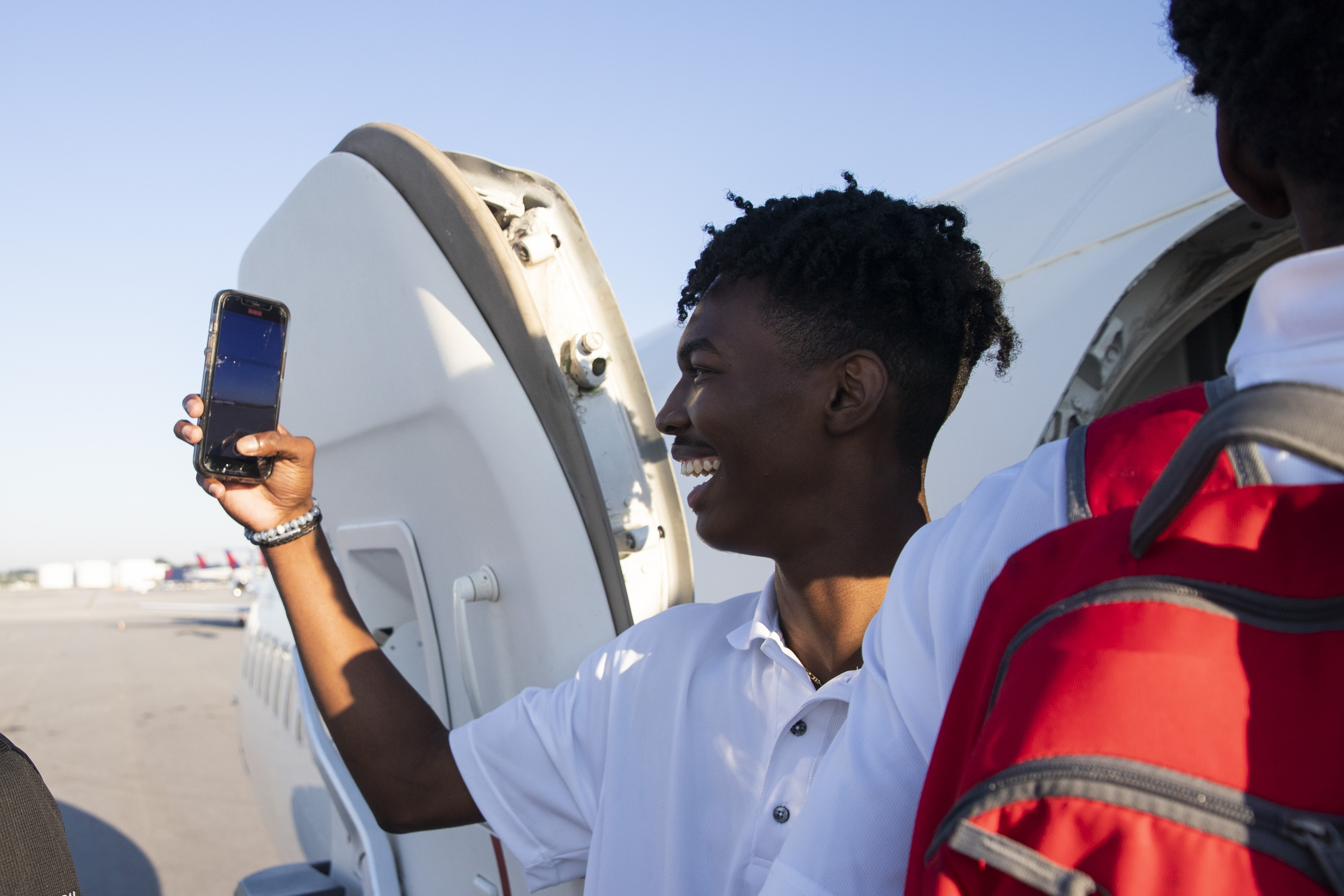 A participant of Delta’s Dream Flight 2022 records the runway before boarding a plane at Hartsfield-Jackson Atlanta International Airport on Friday, July 15, 2022. Around 150 students ranging from 13 to 18 years old will fly from Atlanta to the Duluth Air National Guard Base in Duluth, Minnesota. (Chris Day/Christopher.Day@ajc.com)