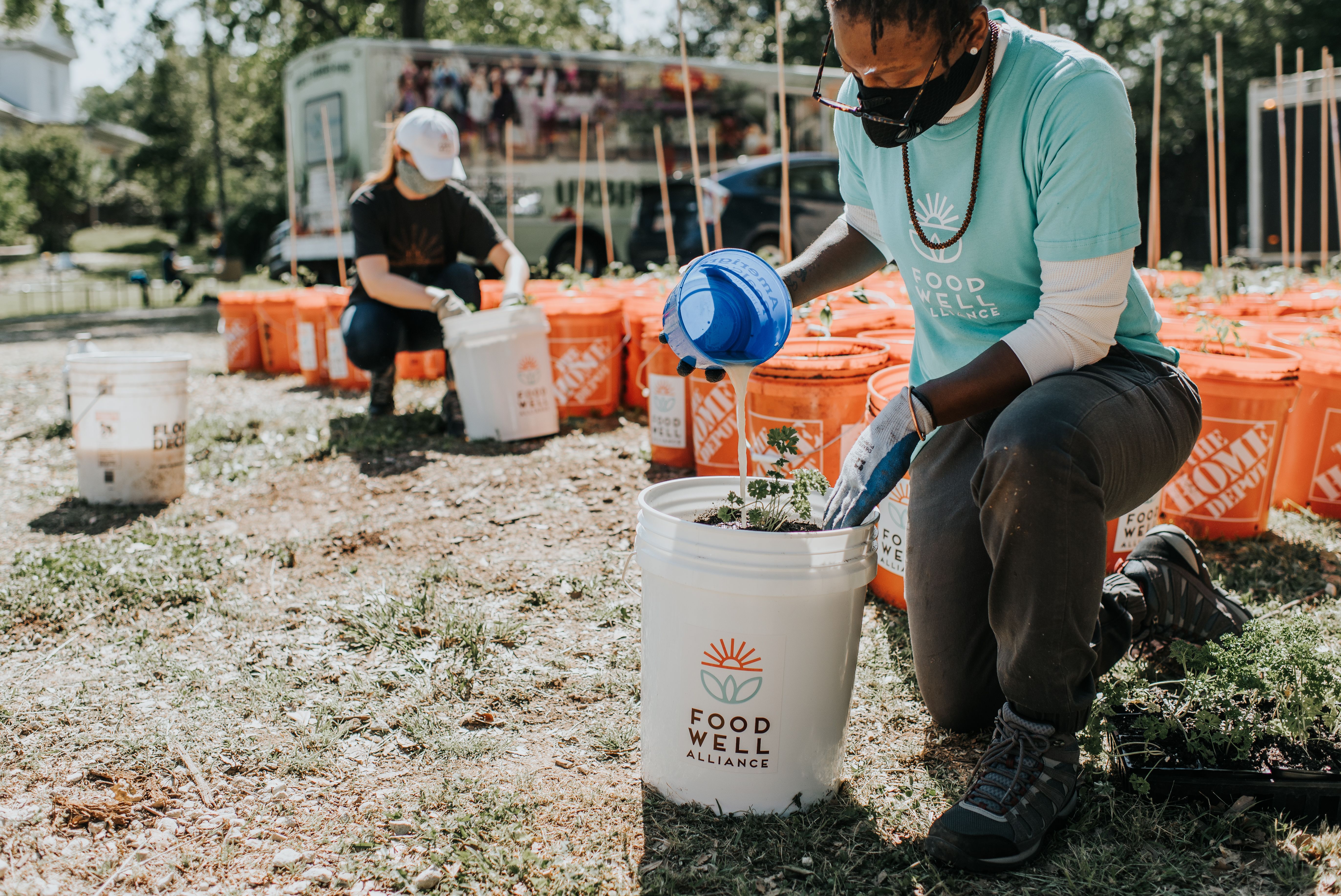 Food Well Alliance staff members prepared bucket gardens for East Point families last spring and summer. Courtesy of Food Well Alliance