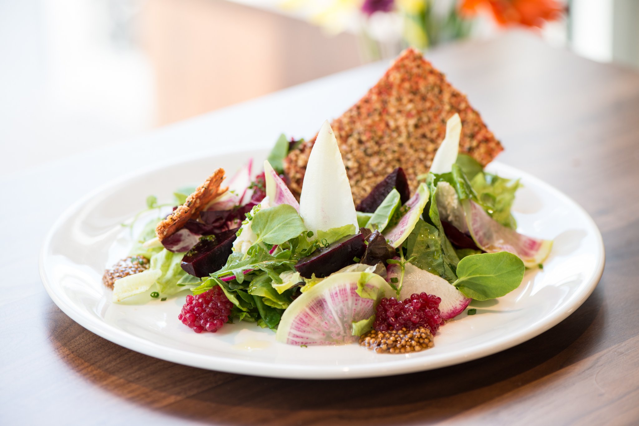 Spring Lettuces with Cucumber Dressing and carrot, beet root, radish, hemp hearts, and Capra Gia chevre. Photo credit- Mia Yakel.