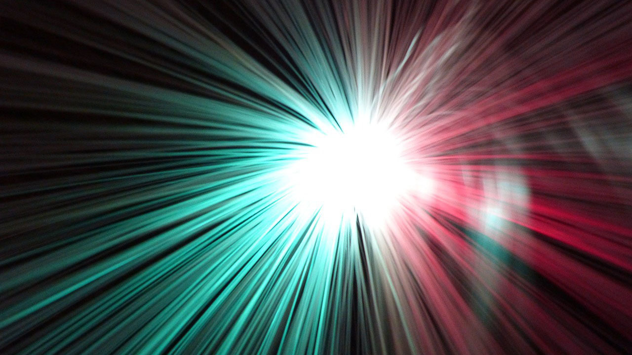 A bright, blinding light glows red and green.