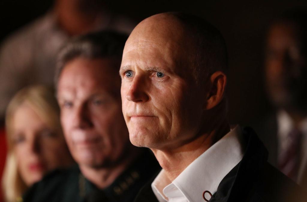 PARKLAND, FL - FEBRUARY 14: Florida Governor Rick Scott speaks to the media as he visits Marjory Stoneman Douglas High School after a shooting at the school killed 17 people on February 14, 2018 in Parkland, Florida. Numerous law enforcement officials continue to investigate the scene. (Photo by Joe Raedle/Getty Images)