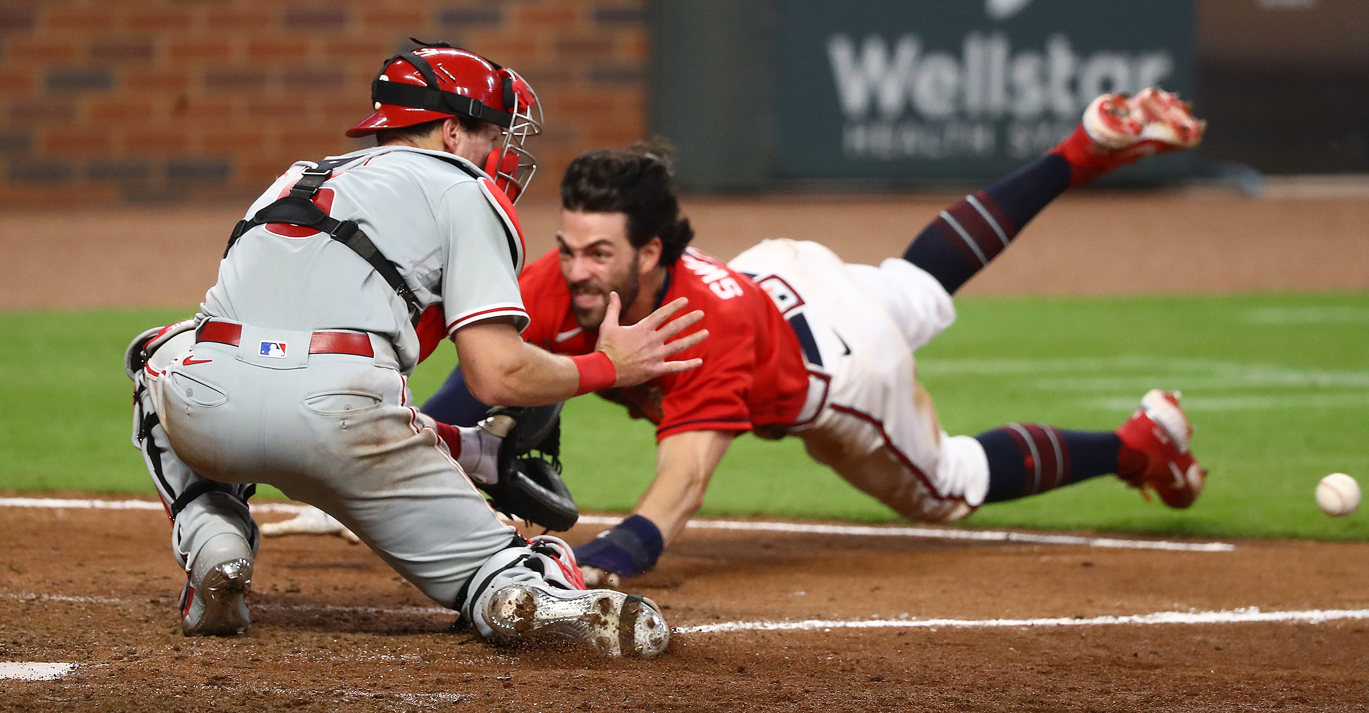 Andrew Knapp's tag of Dansby Swanson broke plate-blocking rules, Braves  manager Brian Snitker says