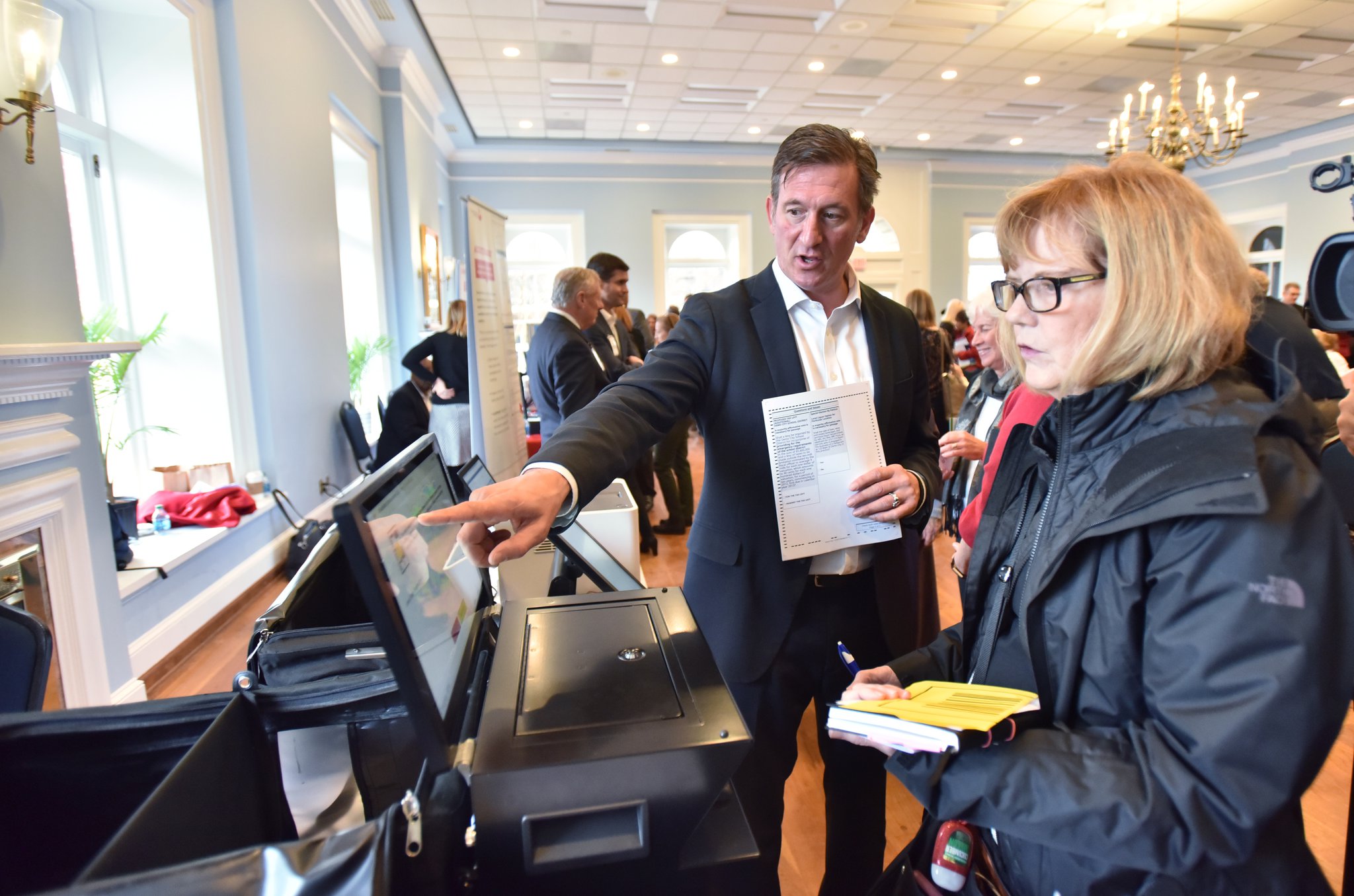 Bill Murphy with Clear Ballot demonstrates his company’s paper ballot system at The Depot on Thursday. Election companies demonstrated voting systems to the public and to officials, showing how Georgia could switch to paper ballots. HYOSUB SHIN / HSHIN@AJC.COM