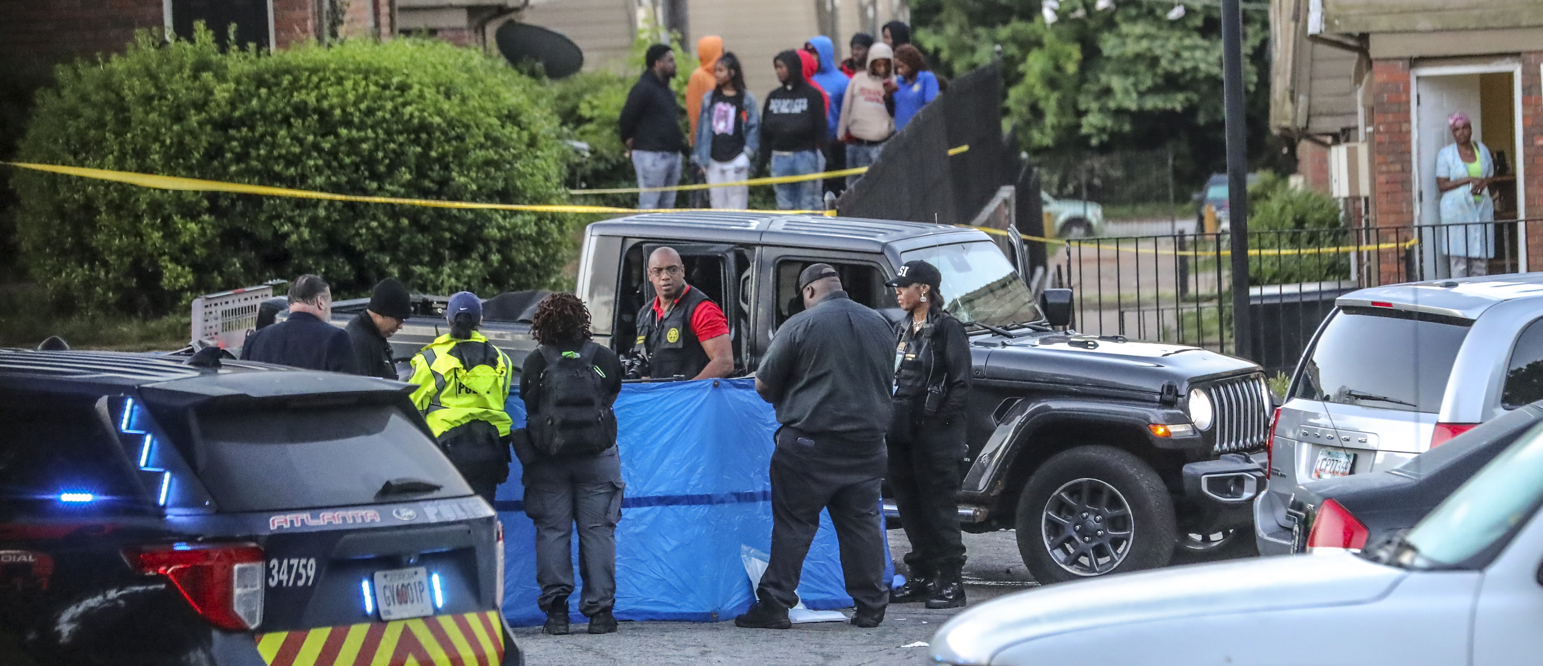 Atlanta police investigate after the body of a shooting victim was found in May at Forest Cove Apartments. Another person was wounded in the shooting. Since 2009, 19 homicides have occurred at Forest Cove, and a judge has ordered that the complex be demolished. (John Spink / John.Spink@ajc.com)
