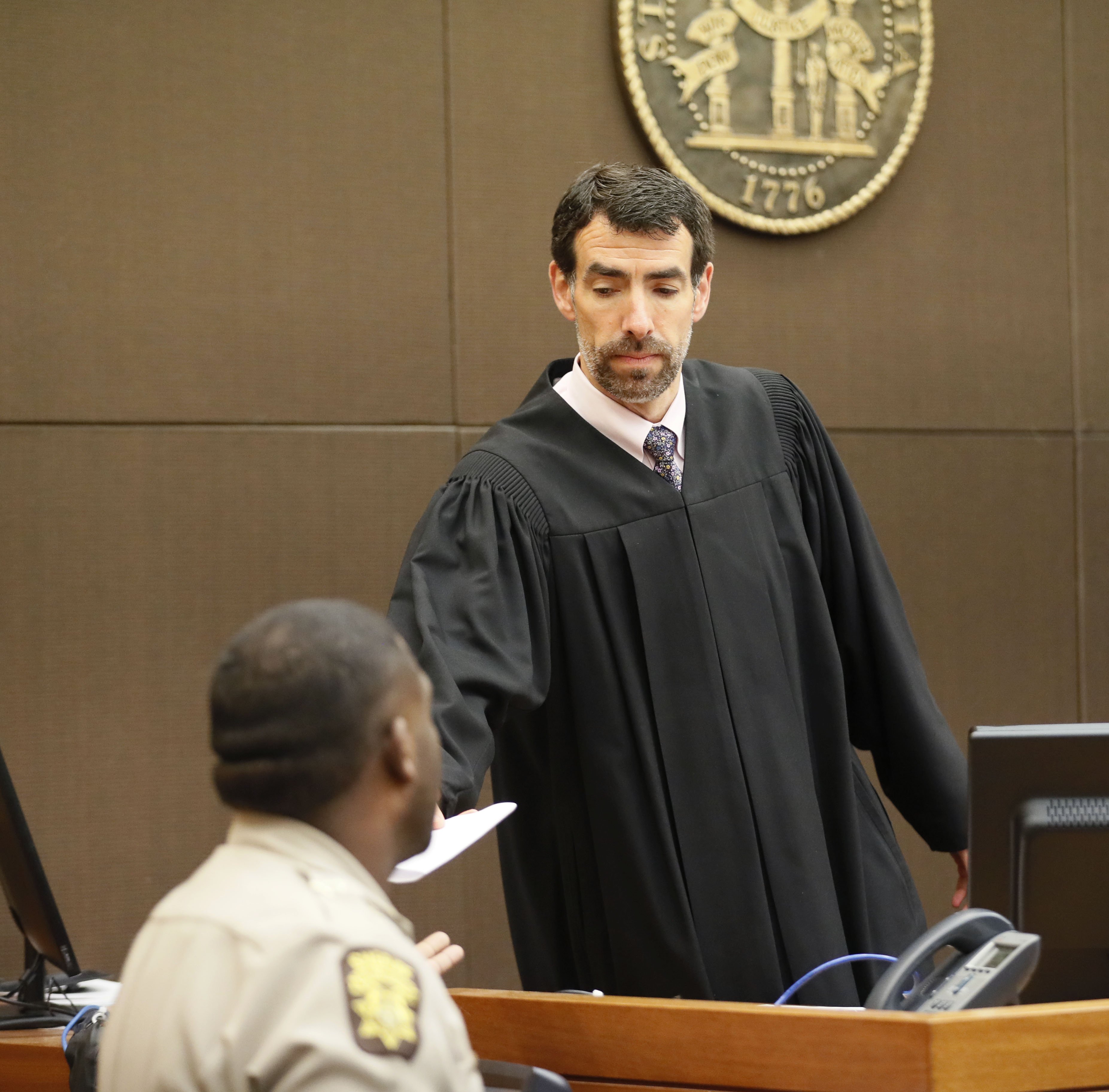 4/23/18 - Atlanta - After reading the verdict, Fulton County Chief Judge Robert McBurney hands it over for the jury foreman to read. The jury found Tex McIver guilty on four of five charges on their fifth day of deliberations today at the Tex McIver murder trial at the Fulton County Courthouse. Bob Andres bandres@ajc.com