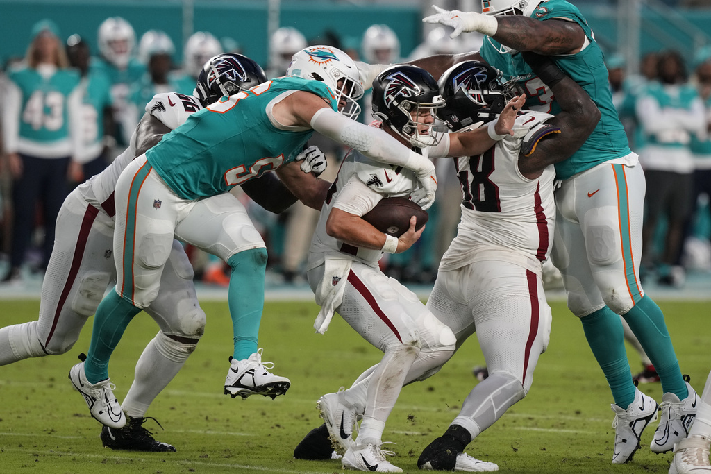 Atlanta Falcons quarterback Taylor Heinicke (4) high fives Atlanta Falcons  offensive lineman Ryan Neuzil (64) as they practice on the field before an  NFL pre-season football game against the Miami Dolphins, Friday