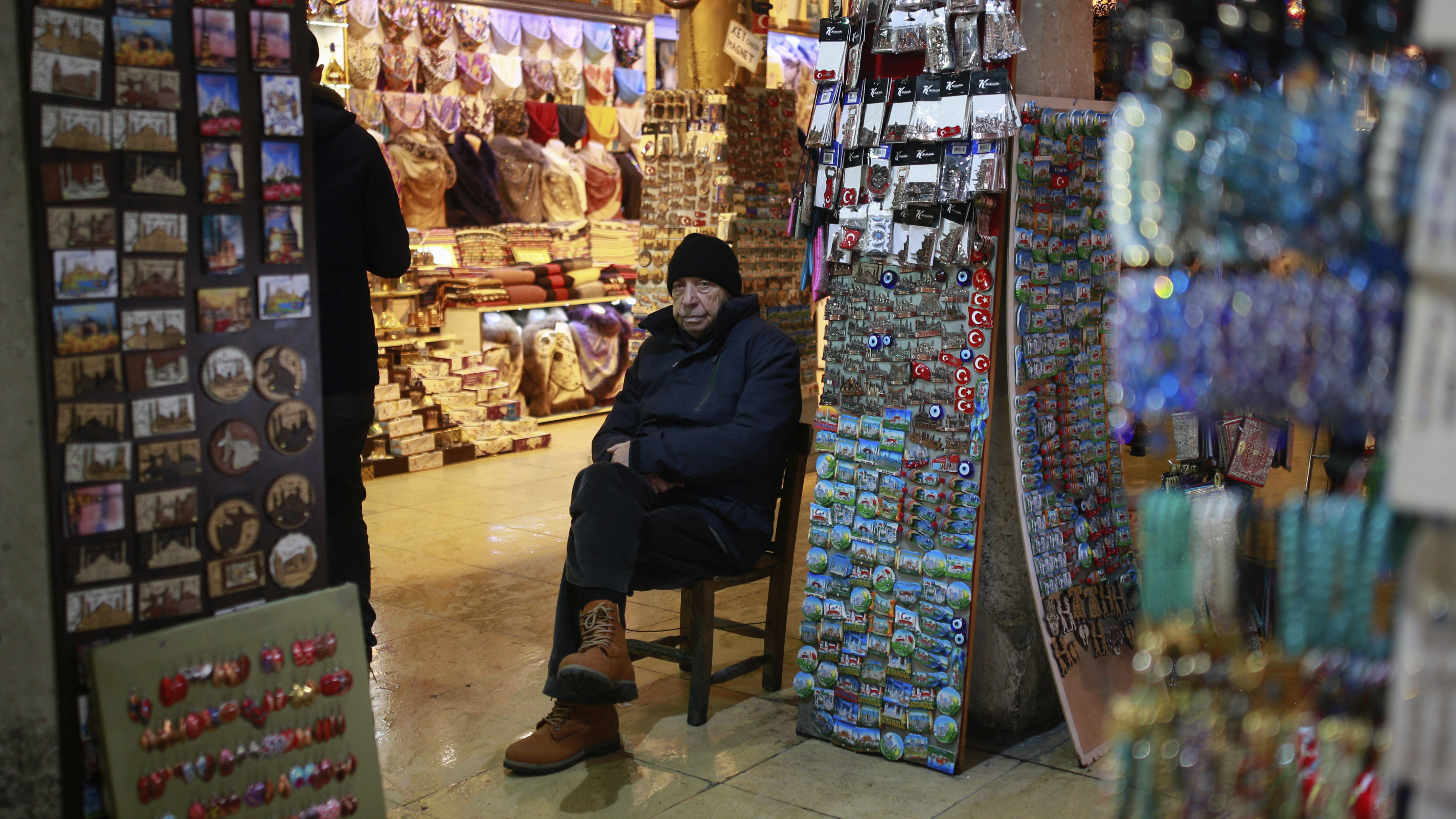 In this Thursday, Jan. 5, 2017 photo, a vendor waits for customers in Istanbul's Grand Bazaar, one of Istanbul's main tourist attractions. Turkey's economy is suffering in the face of a string of extremist attacks -- including this week's nightclub massacre of New Year's revelers, most of them foreigners -- and uncertainty following the failed coup in July against President Recep Tayyip Erdogan that saw more than 270 people killed. (AP Photo/ Emrah Gurel)