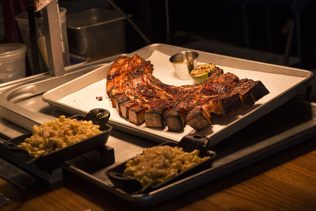The "Puerto Rican Fried Pork Chop" is featured on the Porch Light Latin Kitchen lunch menu. The meal consists of a Loin Chop with ribs, belly, and skin with citrus mojo. (Chad Rhym/ Chad.Rhym@ajc.com)