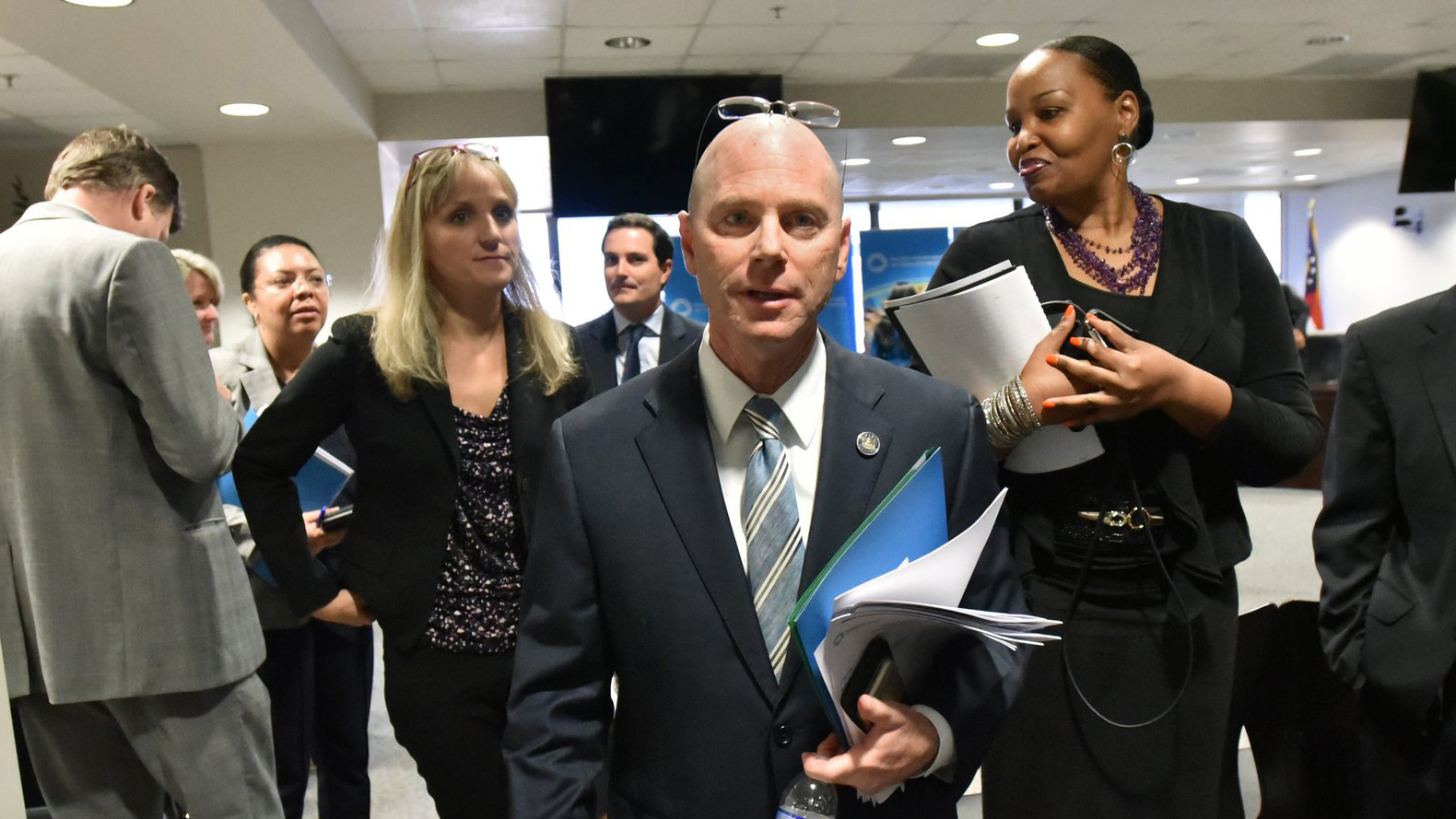 Frank W. Berry, center, Commissioner of Georgia Department of Community Health (DCH), leaves after a board meeting in Atlanta on Aug. 8. The AJC asked to meet with Berry and others at DCH to discuss cases of abuse, neglect and deaths uncoverered by the newspaper’s investigation. Berry would only answer questions in writing. Asked to comment on the deaths and injuries, Berry wrote that “The health and wellbeing of Georgians is always our top priority.” (Hyosub Shin / Hyosub.Shin@ajc.com)