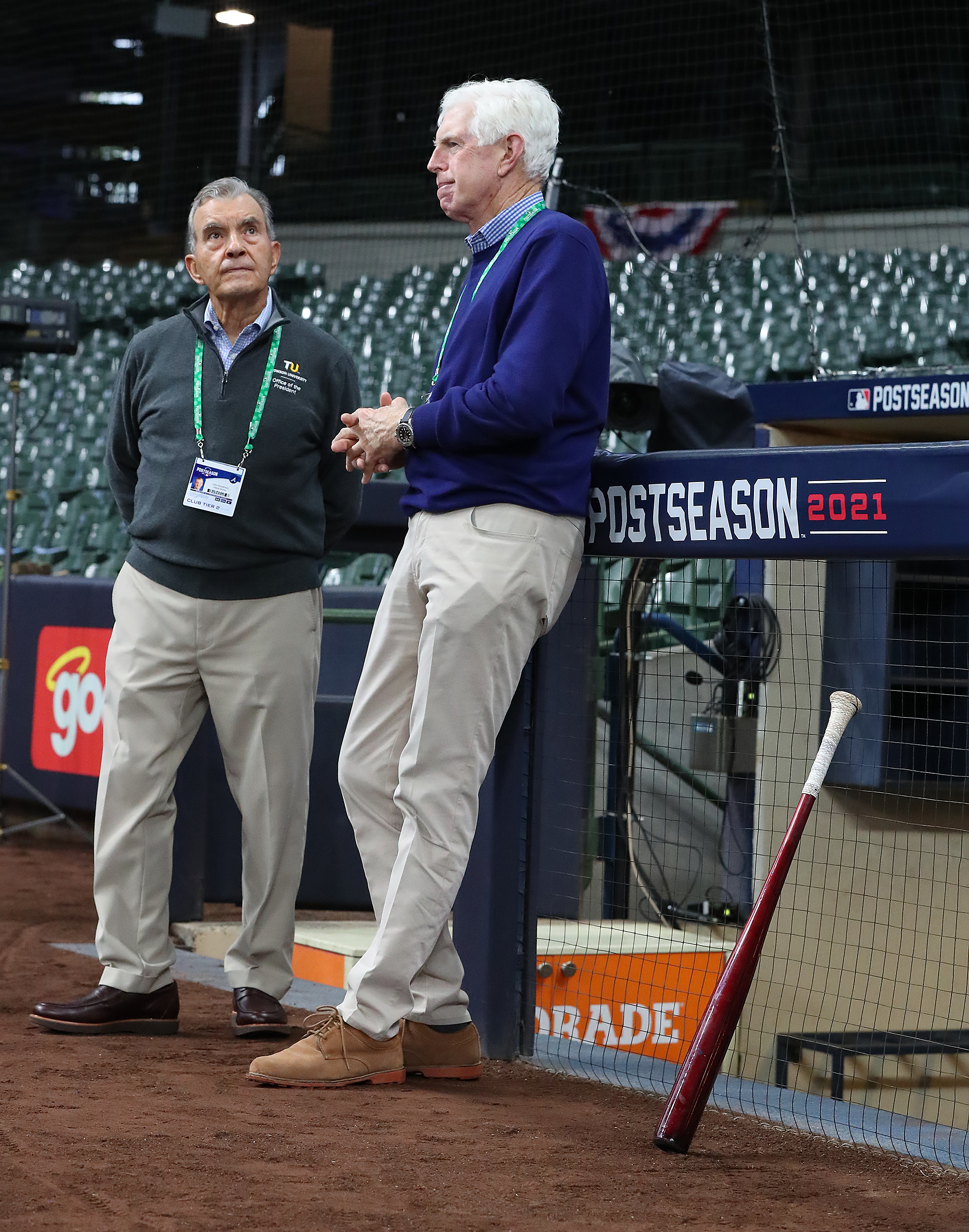 Braves Vice Chairman Emeritus John Schuerholz (left) and Chairman Terry McGuirk (right) watch the team practice at American Family Field in Milwaukee on Oct. 7, preparing for the opening game of the National League Division Series against the Brewers. (Curtis Compton / Curtis.Compton@ajc.com)