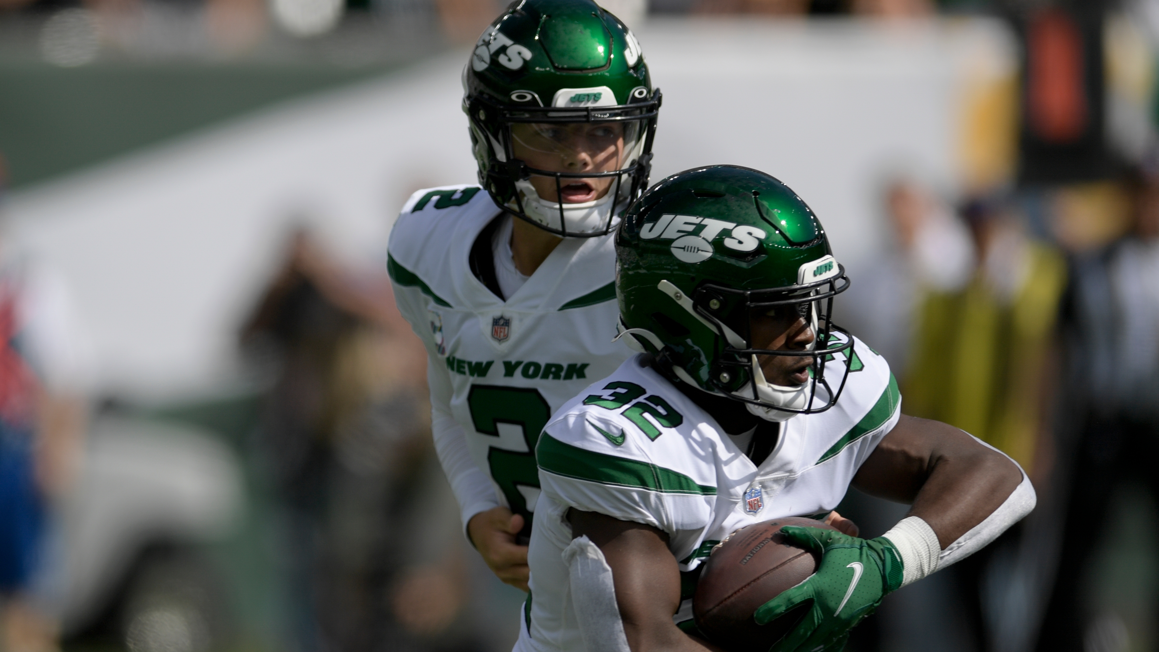 New York Jets running back Michael Carter (32) is tackled during the first  half of an NFL football game between the New York Jets and the Atlanta  Falcons at the Tottenham Hotspur