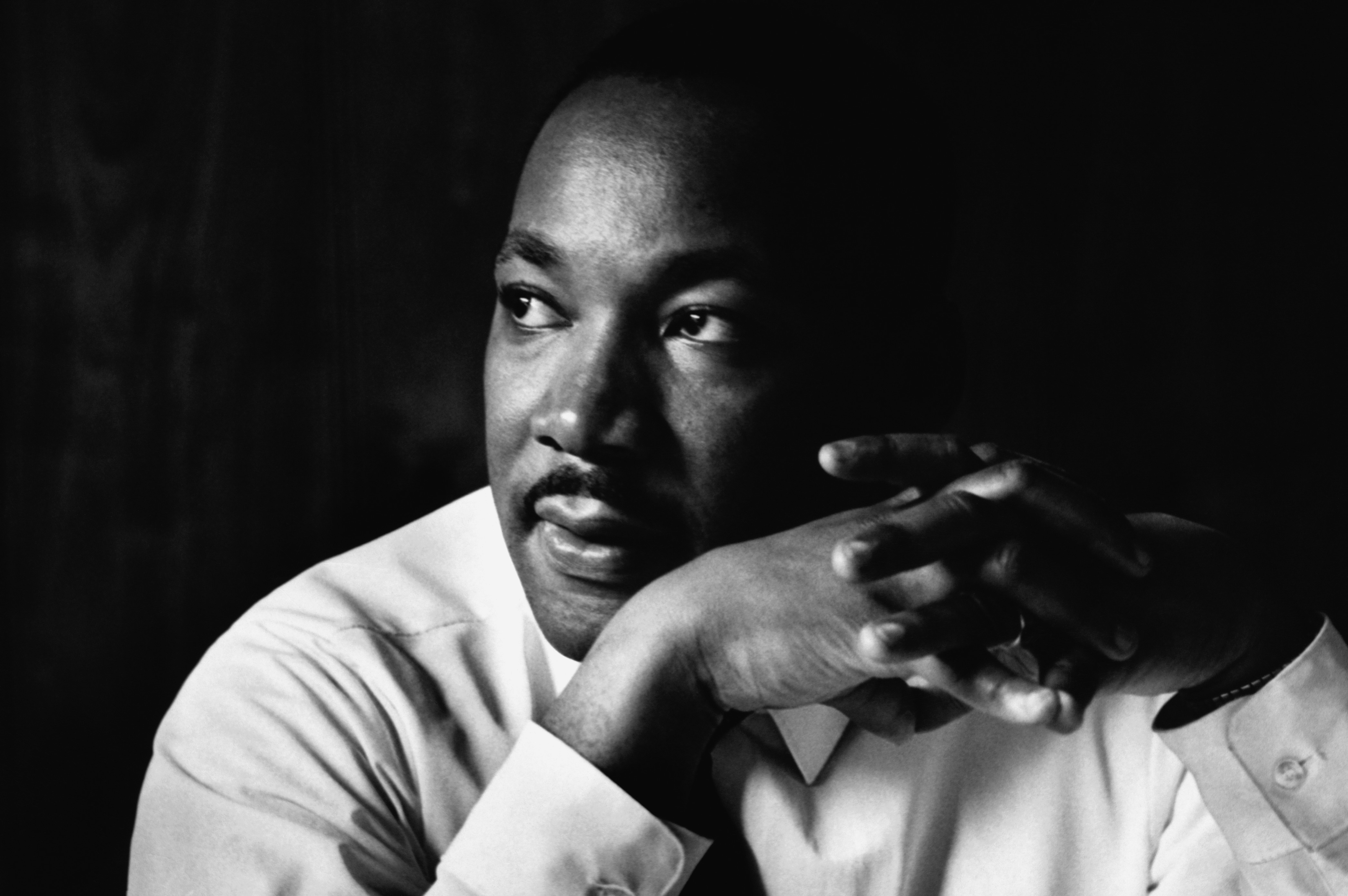 Martin Luther King Jr. listens at a meeting of the Southern Christian Leadership Conference, at a restaurant in Atlanta.