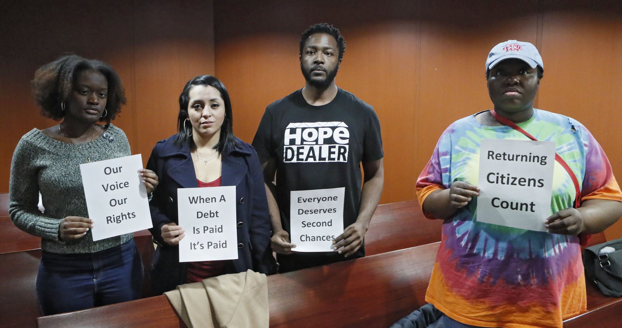 Community organizers for The New Georgia Project, a voting rights group, stood silently with signs after a Senate study commmittee voted against restoring felon voting rights. After a brief discussion, the committee voted Wednesday to maintain the status quo. Bob Andres / bandres@ajc.com