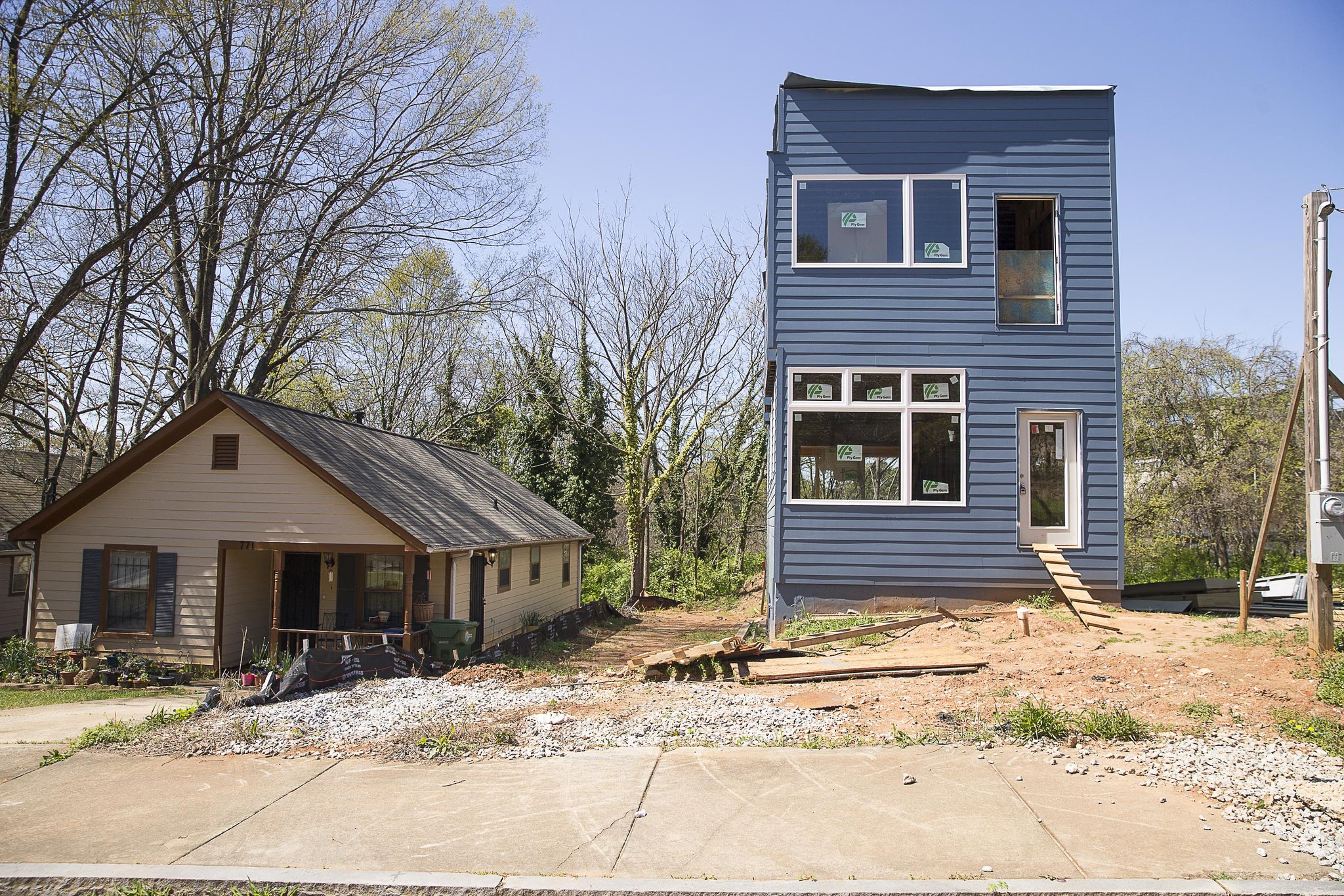 A newly developed house sits next to an older residence in the Summerhill community.