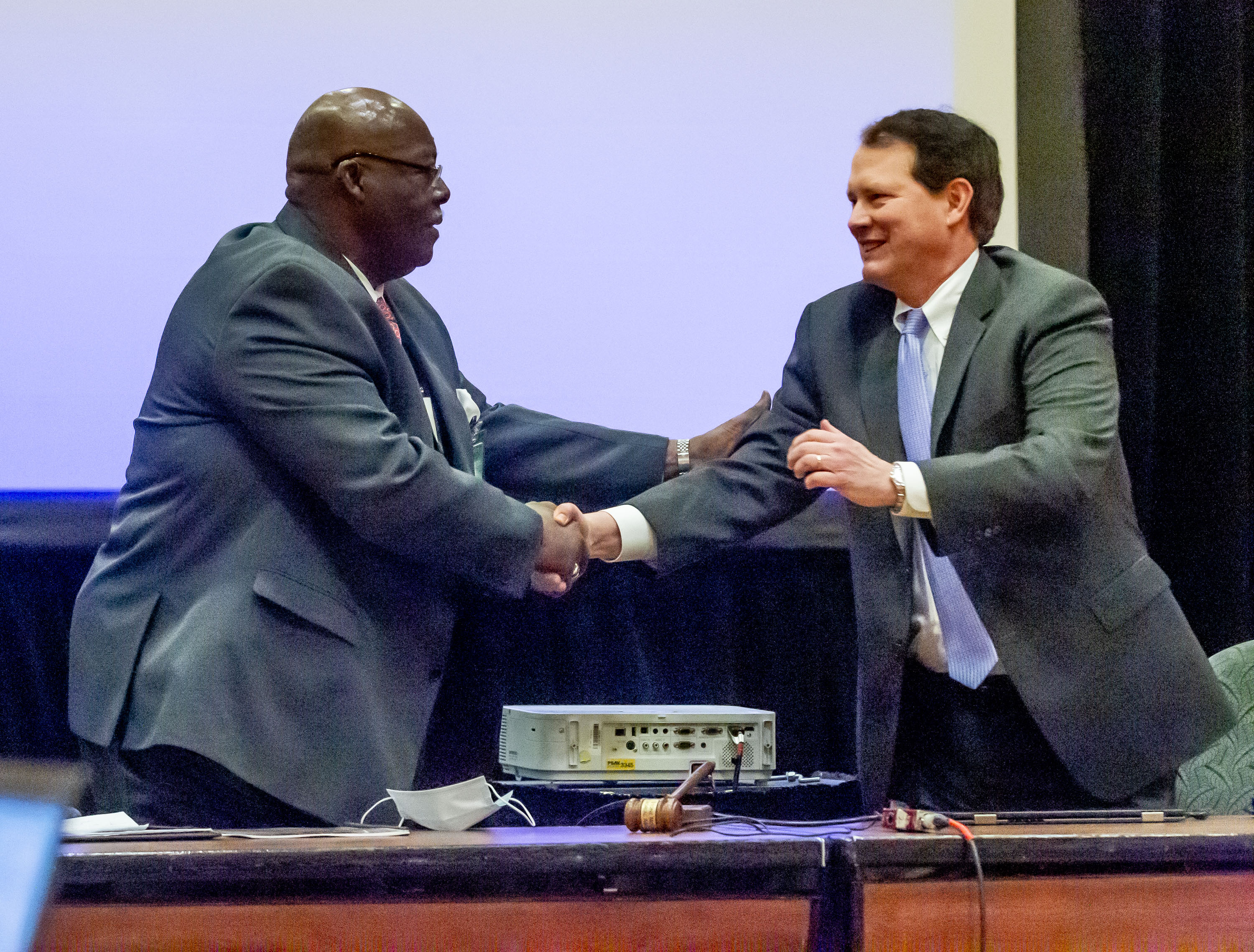 The reverend Abraham Mosley (L) is congratulated on being the new chairman of the Stone Mountain Memorial Association at a meeting Monday at the Evergreen Conference Center at Stone Mountain Park STEVE SCHAEFER FOR THE ATLANTA JOURNAL-CONSTITUTION