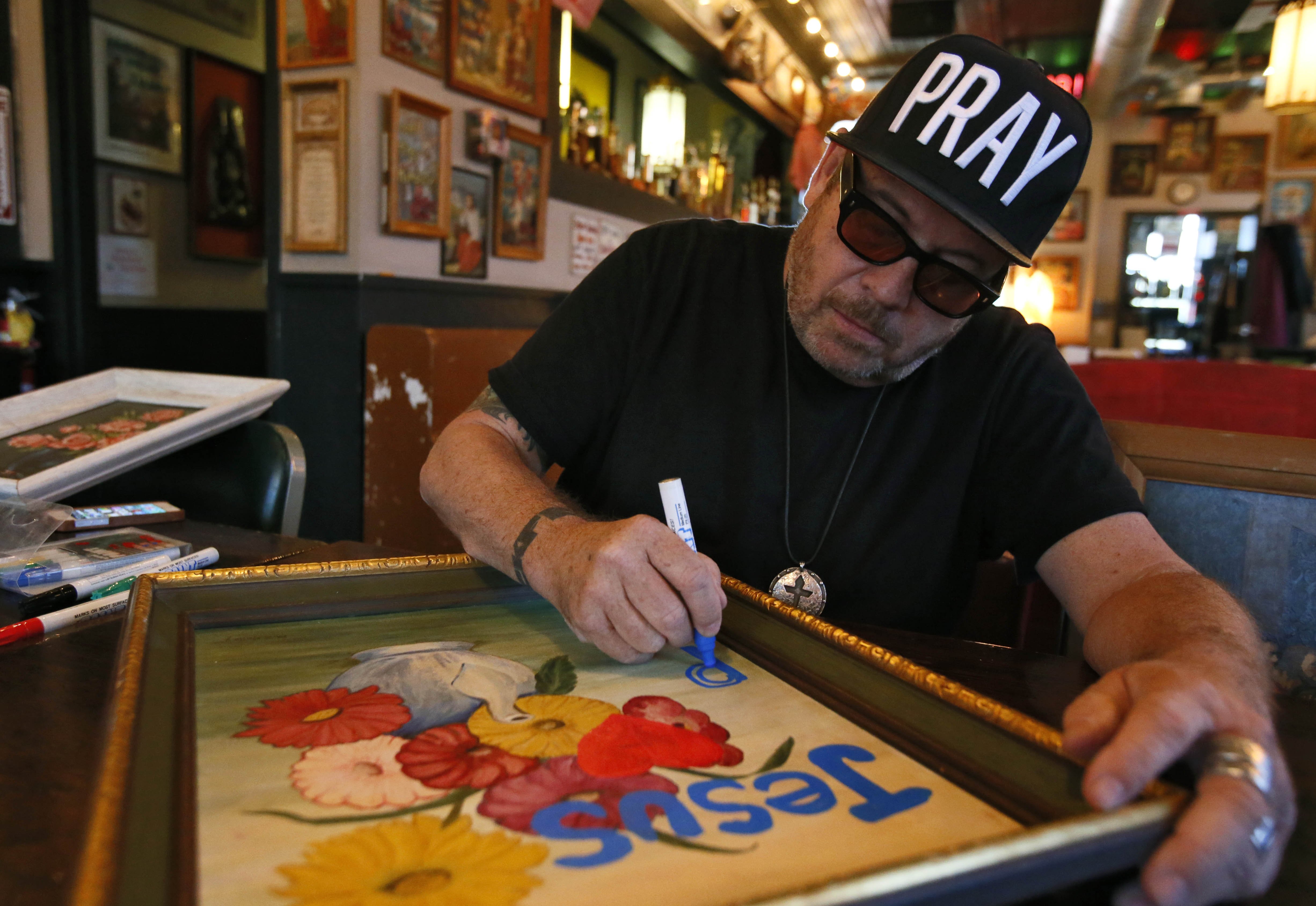 Grant Henry's artwork covers the walls of Church. BOB ANDRES / BANDRES@AJC.COM