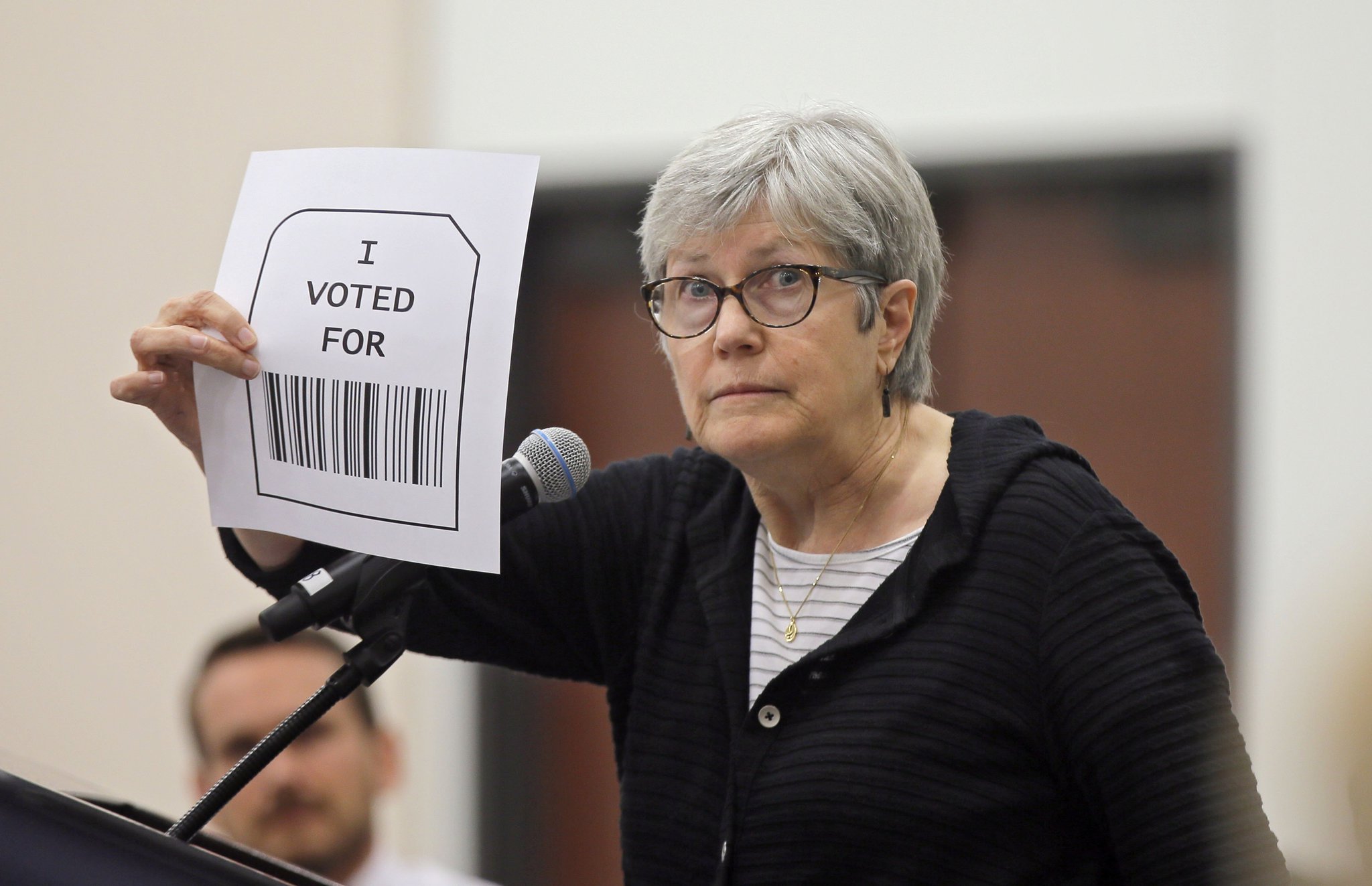 8/30/18 - Grovetown - Susan McWethy, from Decatur, speaks against the use of bar codes and QR codes in vote printouts during public comment period. Voting machine companies demonstrated their products Thursday at the second meeting of Secretary of State Brian Kemp's Secure, Accessible & Fair Elections Commission, which is evaluating whether to switch from electronic voting machines to ones that offer paper ballots for verification and auditing. Vendors present included Clear Ballot, Unisyn Voting Solutions, Smartmatic, Election Systems & Software, Hart InterCivic, and Dominion Voting. BOB ANDRES /BANDRES@AJC.COM