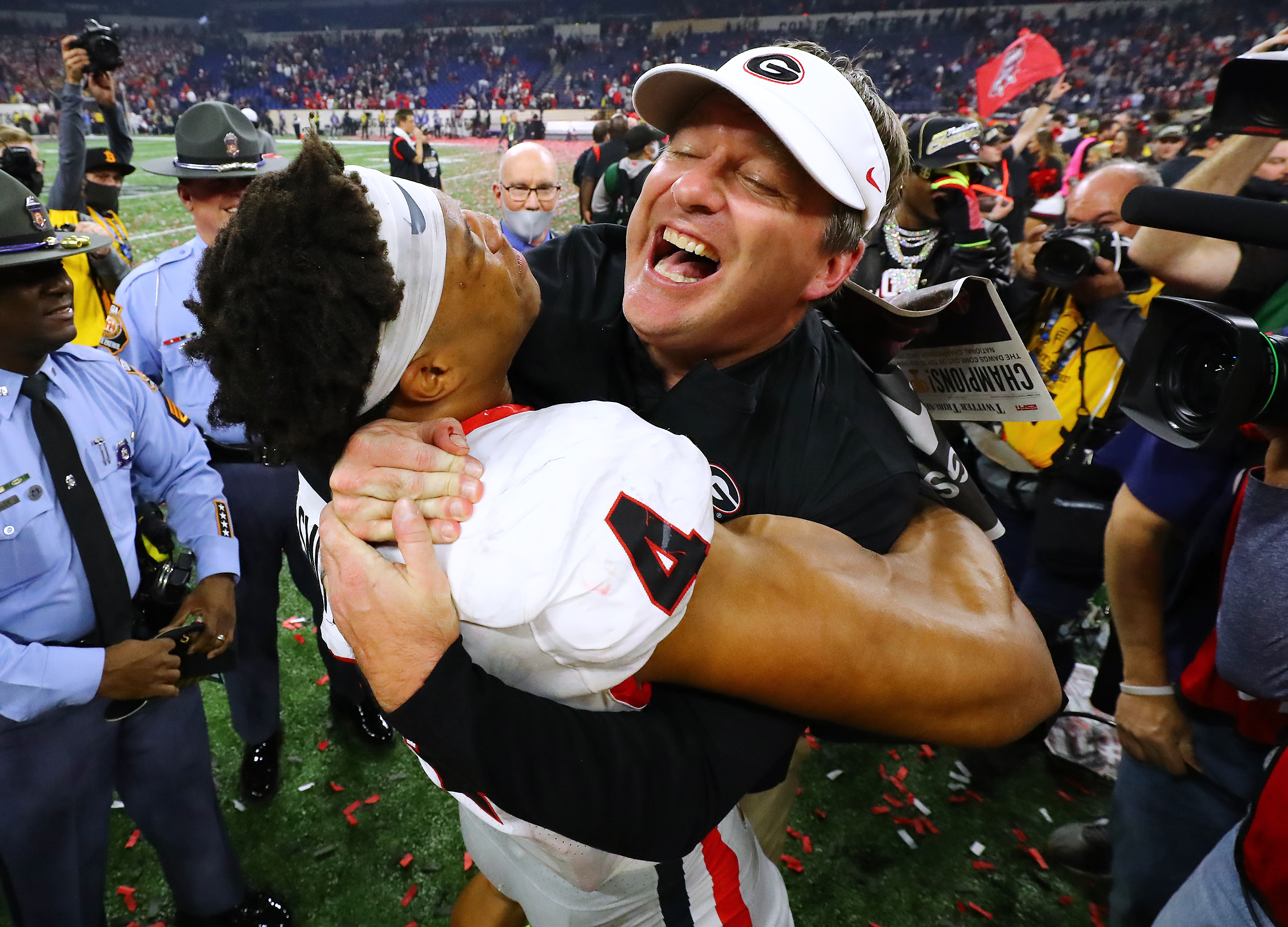 011022 Indianapolis: Georgia head coach Kirby Smart celebrates winning the College Football Playoff Championship game against Alabama getting a hoist from outside linebacker Bolan Smith on Monday, Jan. 10, 2022, in Indianapolis. “Curtis Compton / Curtis.Compton@ajc.com”`