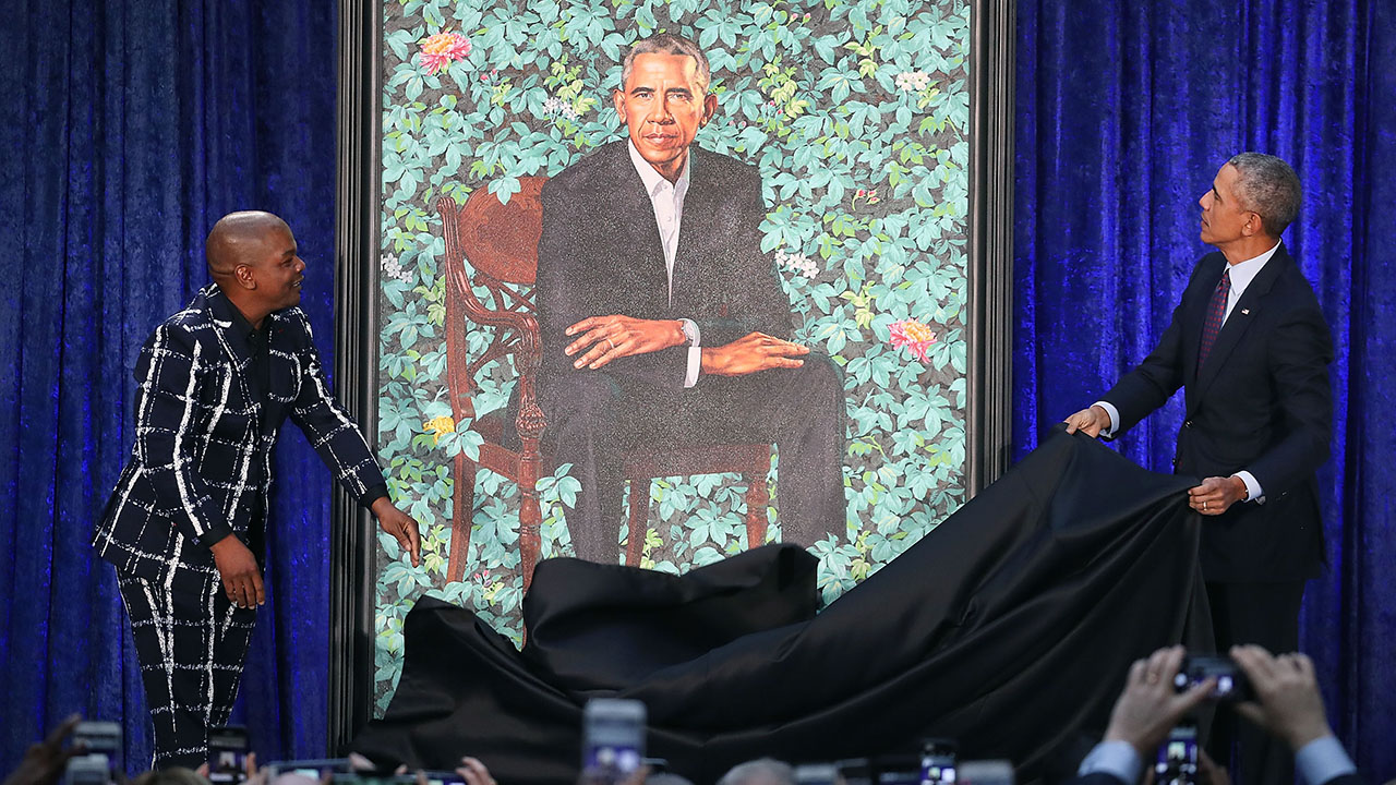 WASHINGTON, DC - FEBRUARY 12: Former U.S. President Barack Obama (R) and artist Kehinde Wiley unveil his portrait during a ceremony at the Smithsonian's National Portrait Gallery, on February 12, 2018 in Washington, DC. The portraits were commissioned by the Gallery, for Kehinde Wiley to create President Obama's portrait, and Amy Sherald that of Michelle Obama. (Photo by Mark Wilson/Getty Images)