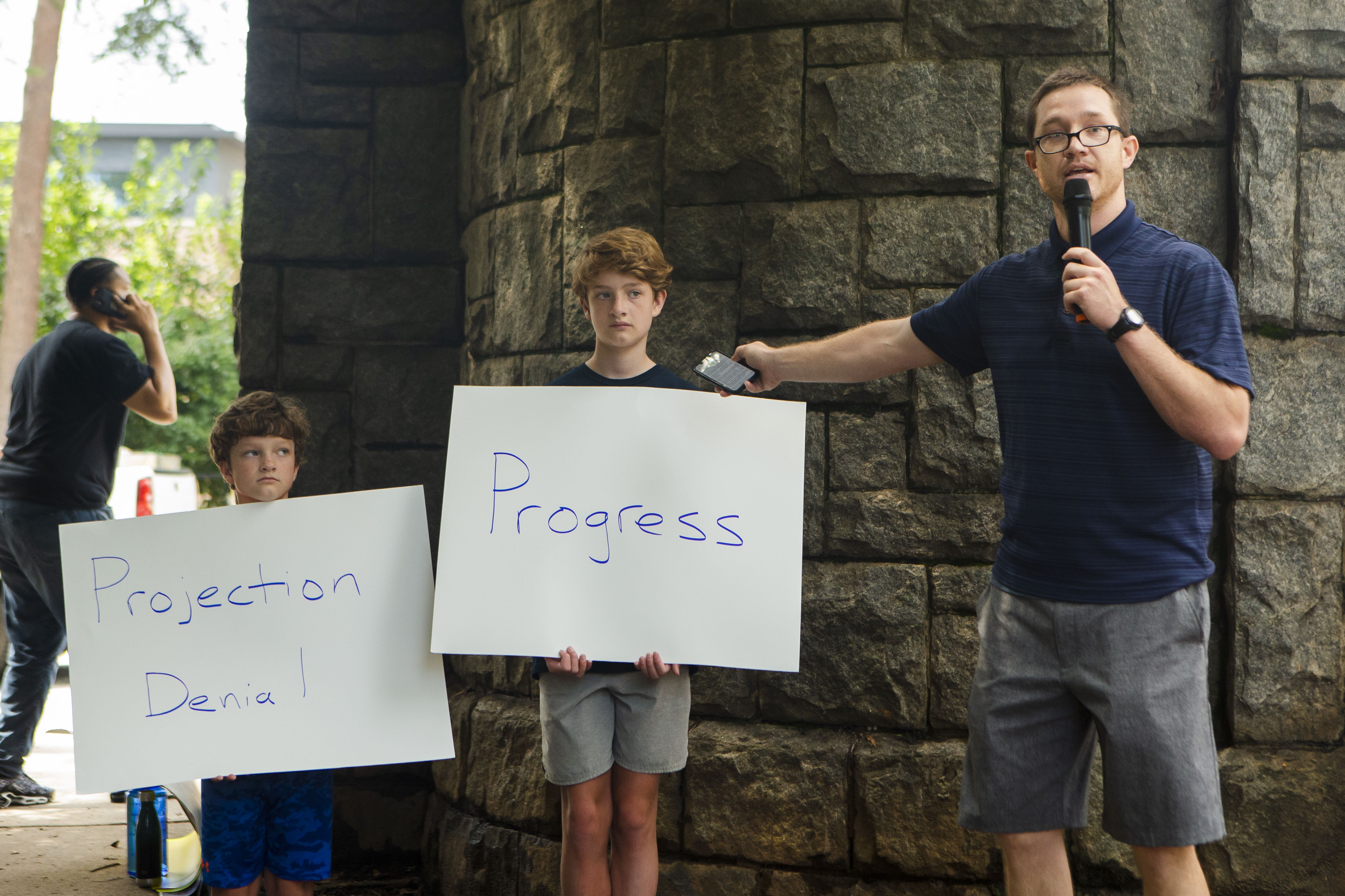 Charlie Copp (right), an educator in Atlanta Public Schools, speaks during a back-to-school rally for Georgia educators accompanied by his sons Charles Baxter Copp (left) and James Bennett Copp (center) on Saturday, July 23, 2022, at Piedmont Park in Atlanta. Teachers, community members and students gathered to speak against new state laws that limit classroom discussions about race and streamline the process for banning books in schools. (Christina Matacotta for The Atlanta Journal-Constitution)
