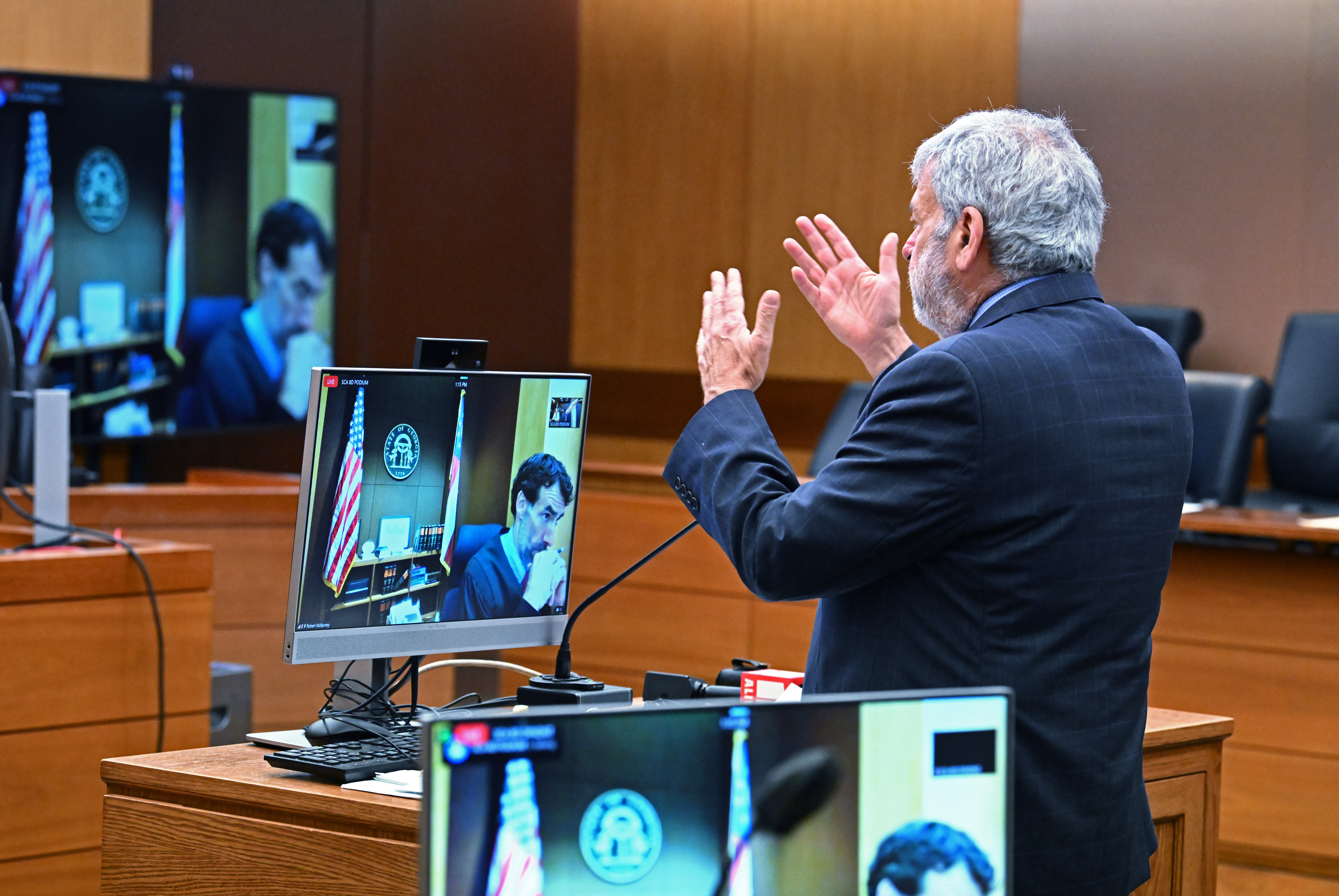 Legislators’ attorney Don Samuel speaks to Fulton Superior Court Judge Robert McBurney (on tv monitor) during a motion hearing at Fulton County Courthouse in Atlanta on Friday, July 1, 2022. Fulton Superior Court Judge Robert McBurney at a roughly 90-minute hearing Friday did not come to a final decision about what exactly the District Attorney’s office can ask Lt. Gov. Geoff Duncan, former state Sen. William Ligon of Brunswick and several other unnamed state legislators. But he said that anything related to their conversations with other legislators or motivations are off-limits. (Hyosub Shin / Hyosub.Shin@ajc.com)
