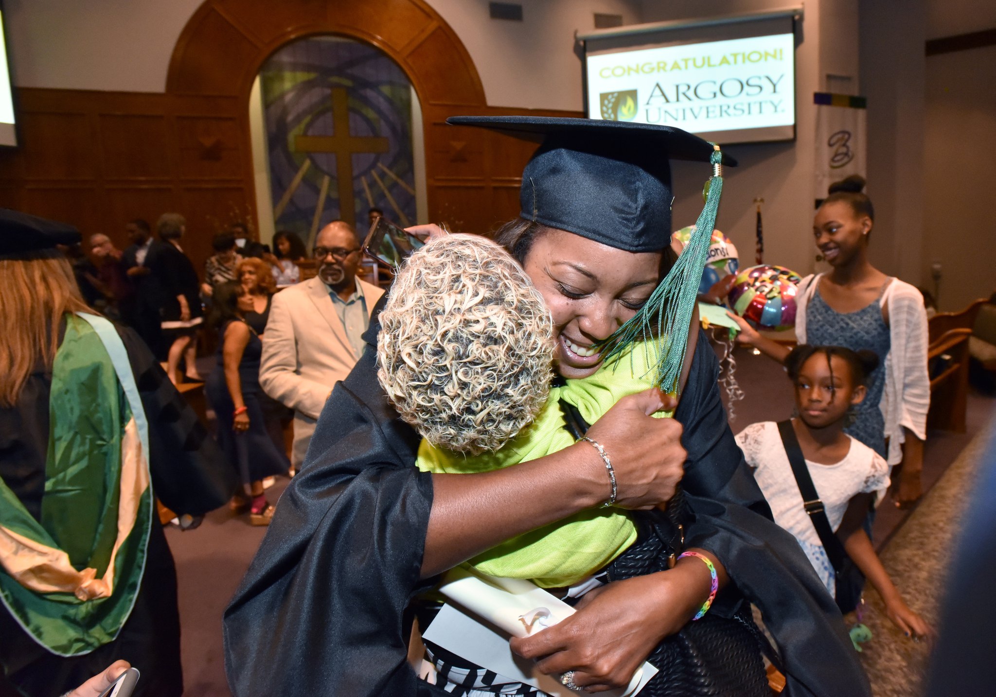 June 8, 2019 Atlanta - Cheryl Walker hugs her friend Camille Jackson after she received her degree during 2019 Argosy University Atlanta Commencement at Church of Christ at Bouldercrest in Atlanta on Saturday, June 8, 2019. HYOSUB SHIN / HSHIN@AJC.COM