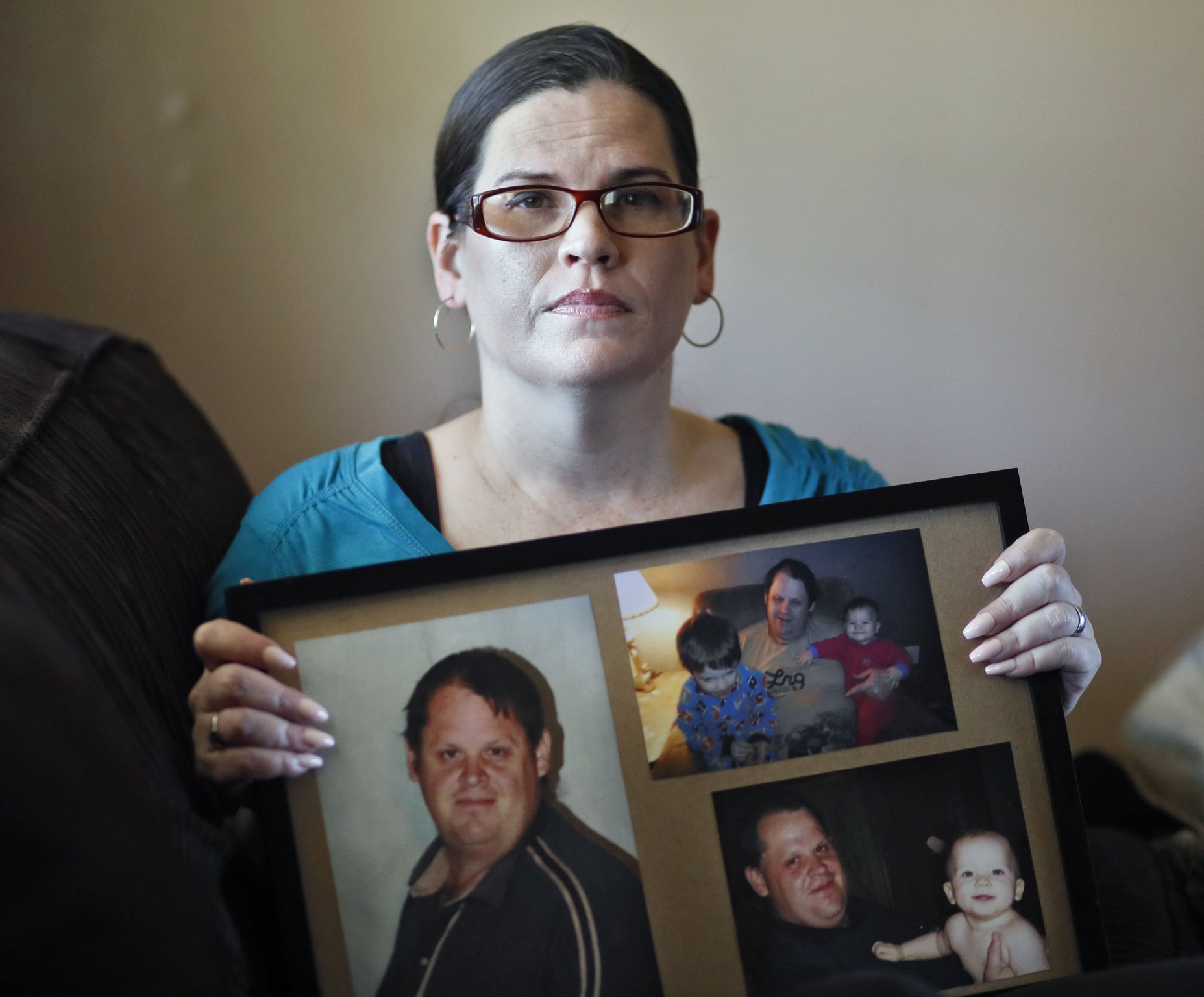 Jennifer Doxakis holds photos of her brother, 39-year-old Jason Brady, who she believes died because of poor care by EMS officials.