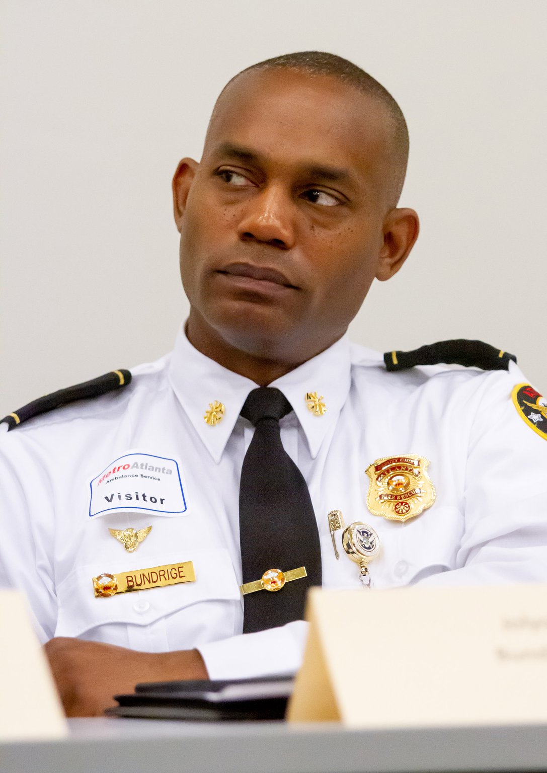 Jolyon Bundrige, Deputy Chief of EMS of the Atlanta Fire Rescue Department, listens to other council members talk during a meeting of the regional EMS council in Marietta in May.