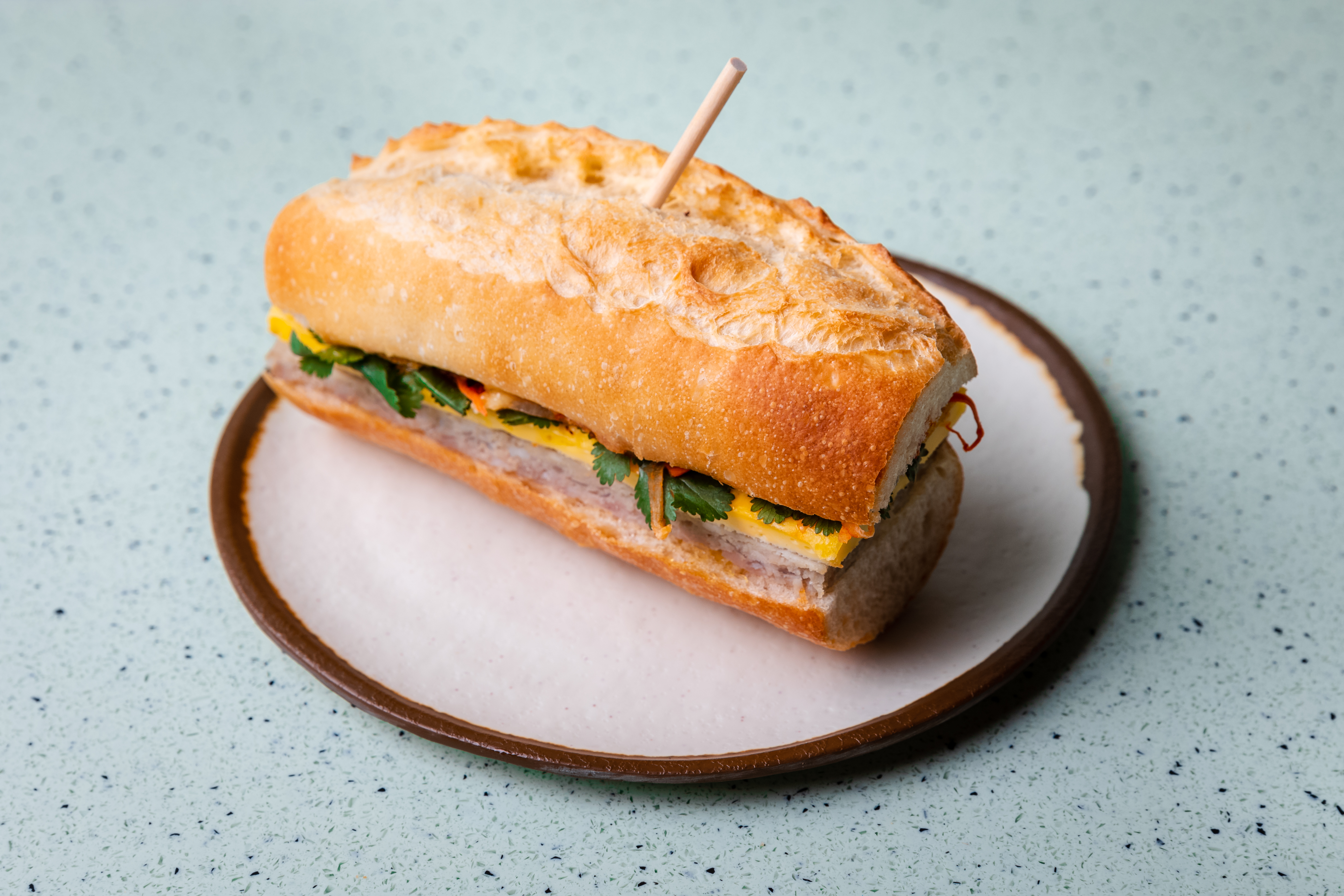 The Breakfast Banh Mi at Juniper Cafe features house-made pork sausage seasoned with lemongrass, ginger, and garlic, hoisin and honey. Photo by Eric Sun