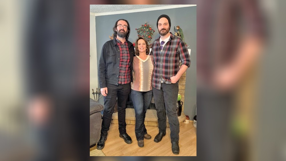 A recent photo of Tina Davis with her two sons. Davis can now walk with the assistance of crutches.