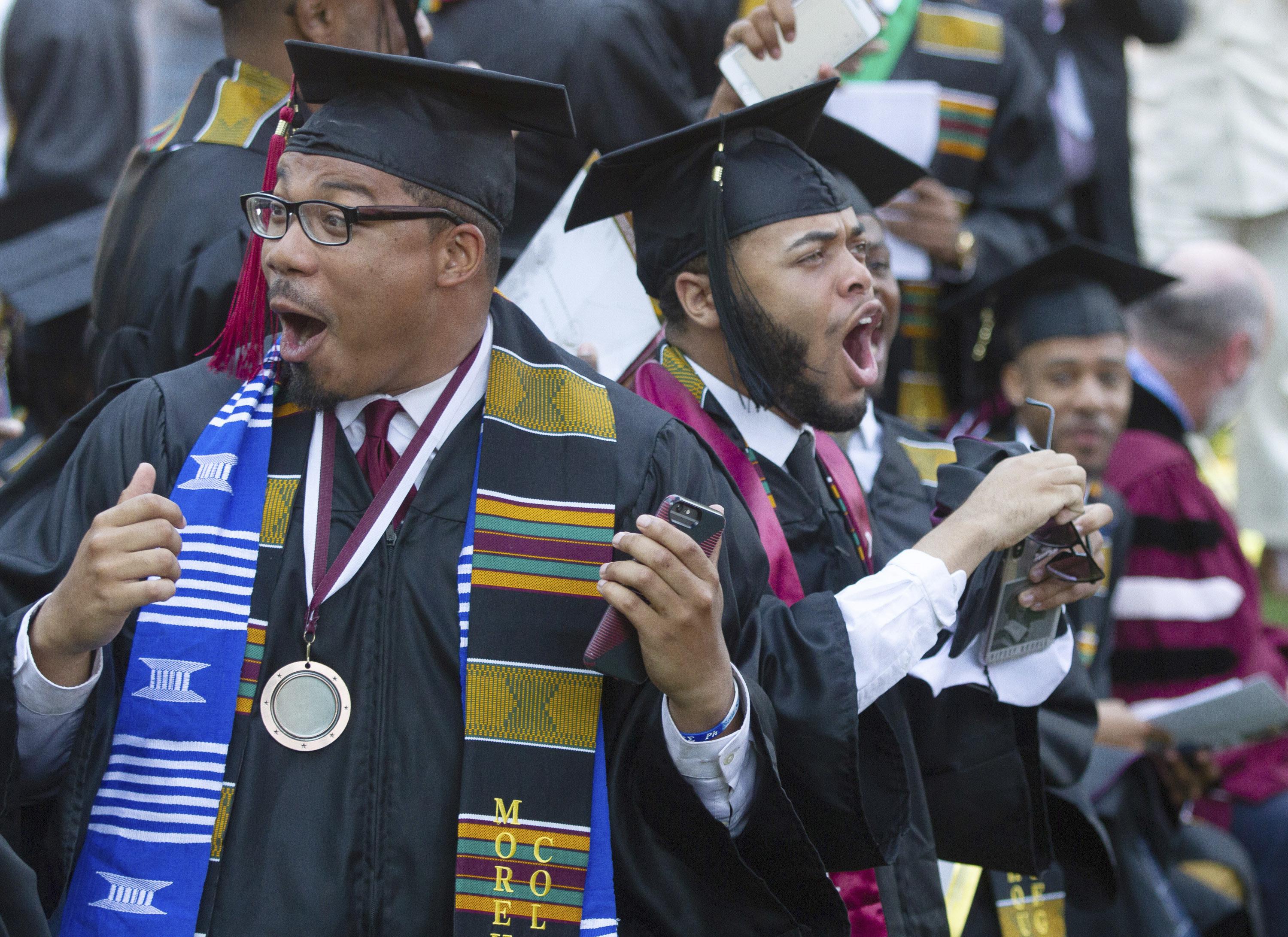 Graduates react after hearing billionaire technology investor and philanthropist Robert F. Smith say he will provide grants to wipe out the student debt of their entire graduating class at Morehouse College in Atlanta. (Steve Schaefer for The Atlanta Journal-Constitution / 2019)
