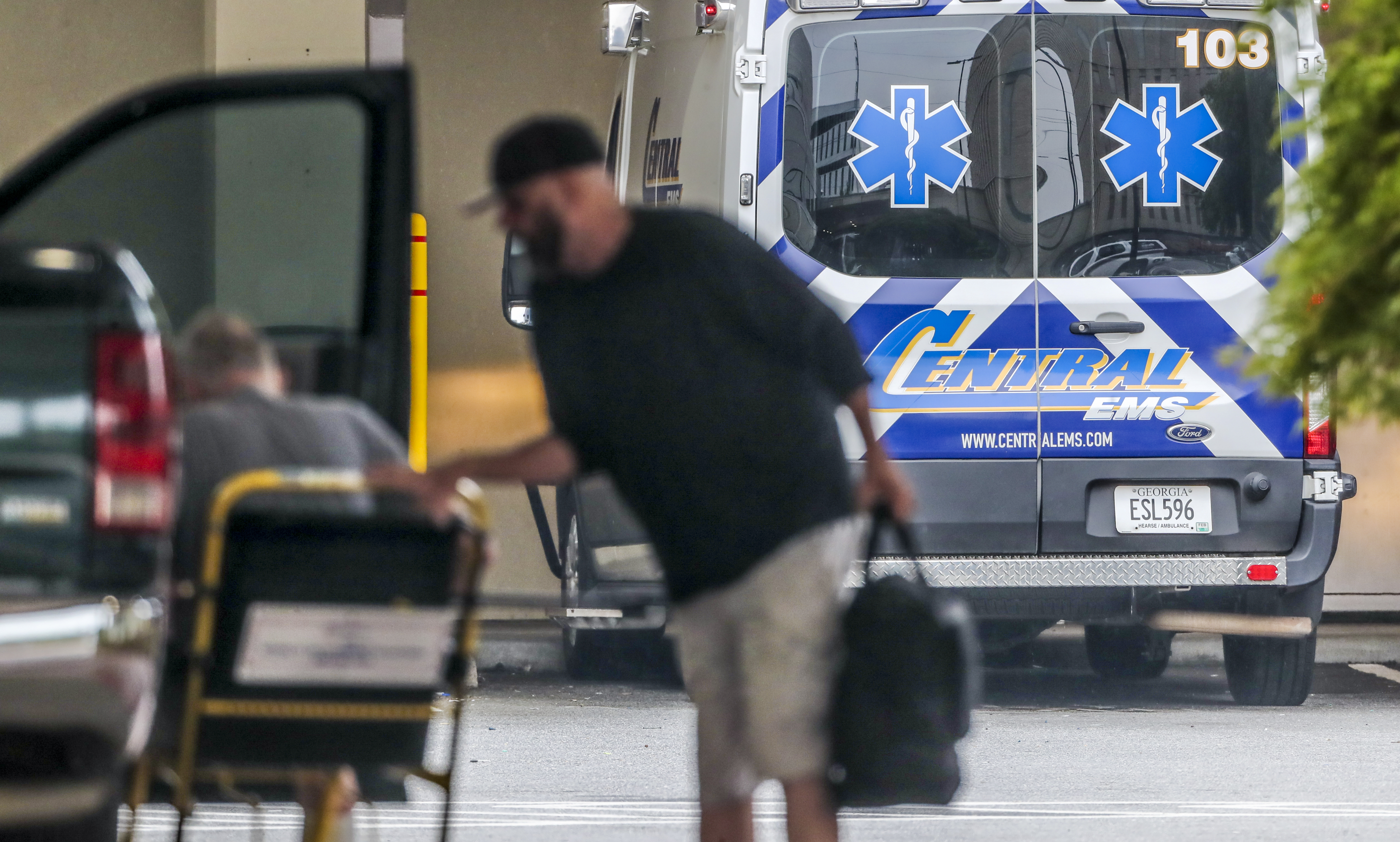 A patient is helped from a vehicle at the emergency entrance at Wellstar Atlanta Medical Center on Boulevard in Atlanta on Wednesday. Statewide, nearly a third of all hospitalized patients — totaling 5,327 — were being treated for COVID-19. That is a drop from the pandemic peak of just over 6,000 two weeks ago. (John Spink / John.Spink@ajc.com)