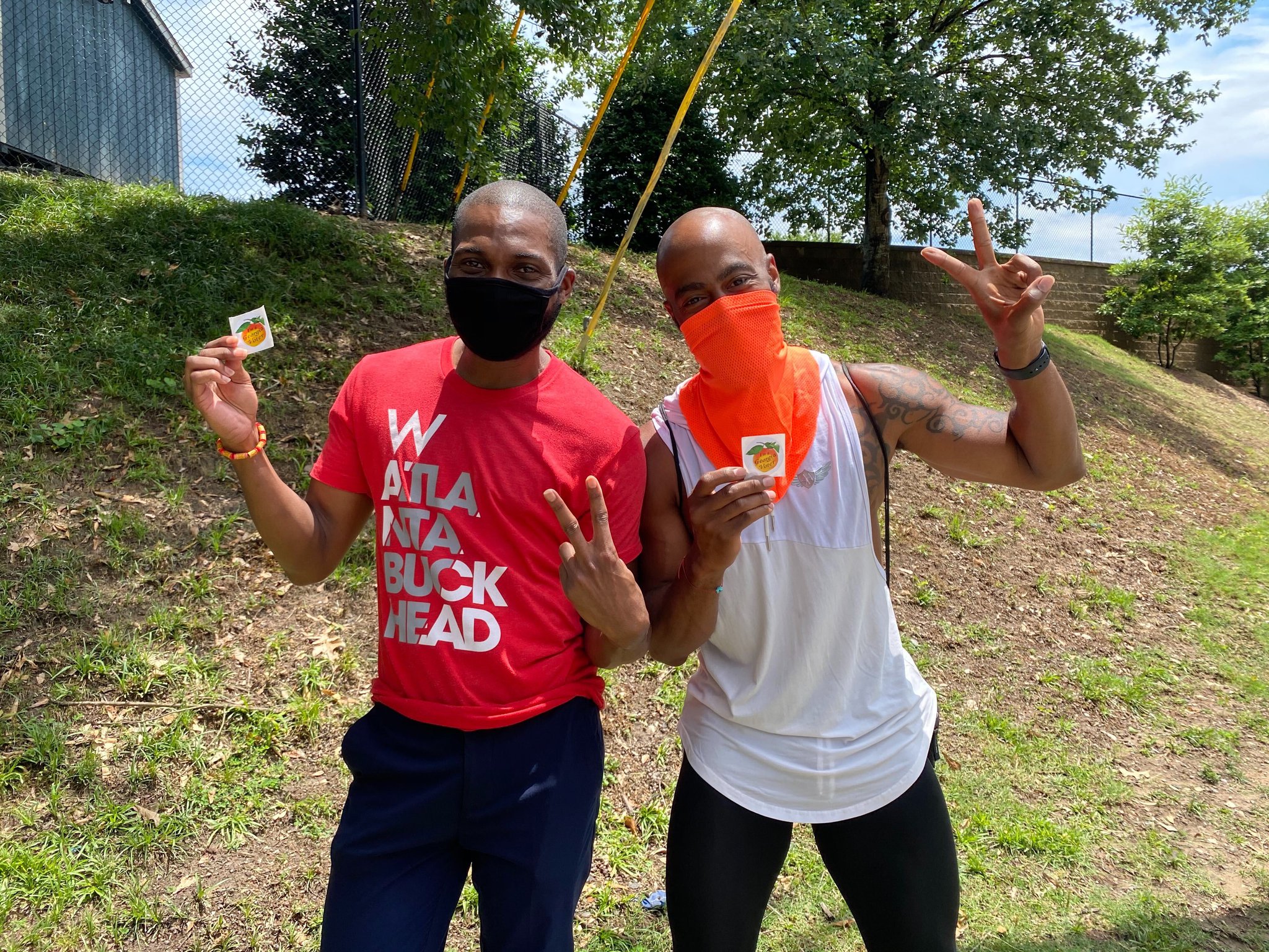 Joshwa Preston (left) and Denerick Lindsey pose with their “I am a Georgia voter!” stickers after waiting three hours to cast their ballots at Garden Hills Elementary School on Friday, June 5, 2020. It was the last day of early voting for this election season. (Ben Brasch/AJC)