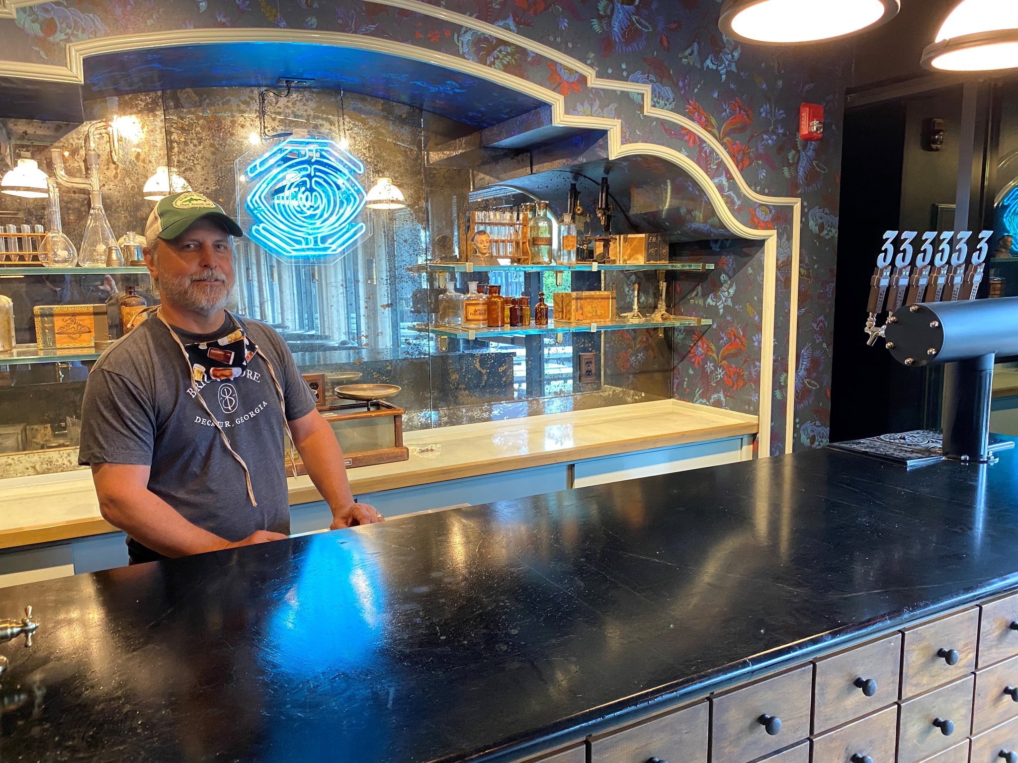 Brian Purcell stands behind the bar inside Three Taverns Imaginarium. Bob Townsend for The Atlanta Journal-Constitution