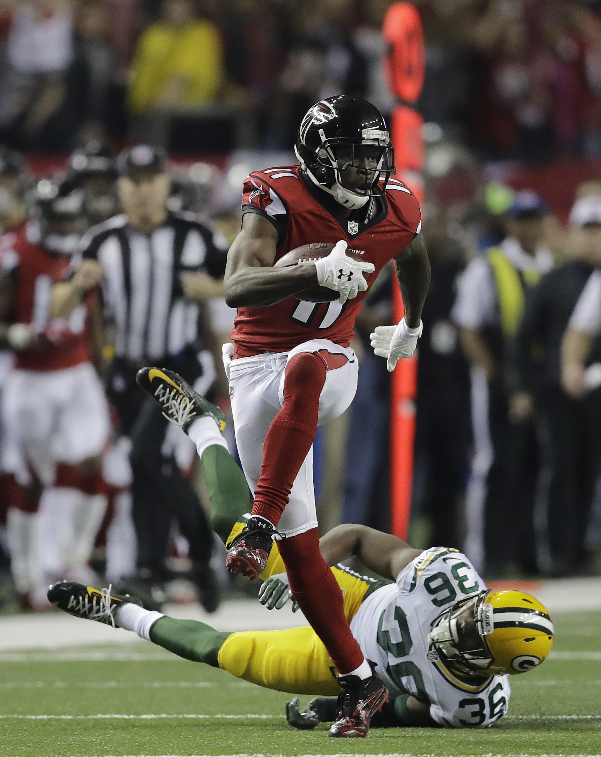 FILE - In this Jan. 22, 2017, file photo, Atlanta Falcons' Julio Jones catches a touchdown pass in front of Green Bay Packers' LaDarius Gunter during the second half of the NFL football NFC championship game, in Atlanta. Atlanta led the NFL in points (540) by a wide margin, thanks to a career year from QB Matt Ryan (2), who along with WR Julio Jones (11) are All-Pros. The Falcons (13-5) take on the New England Patriots (16-2) in Super Bowl LI in Houston on Feb. 5, 2017. (AP Photo/David Goldman, File)